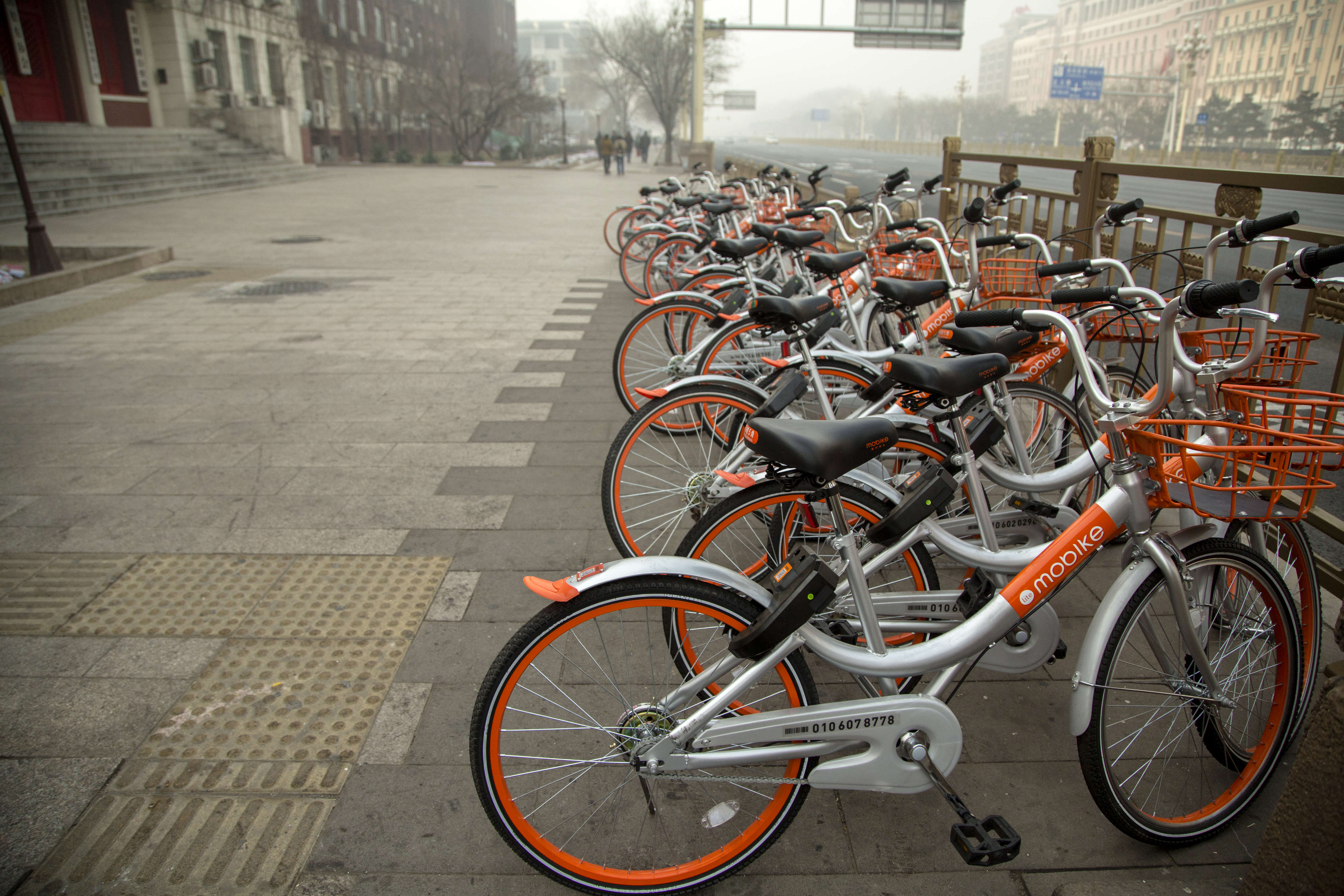 Mobikes bikes lined up on the streets.  Mobike is one of