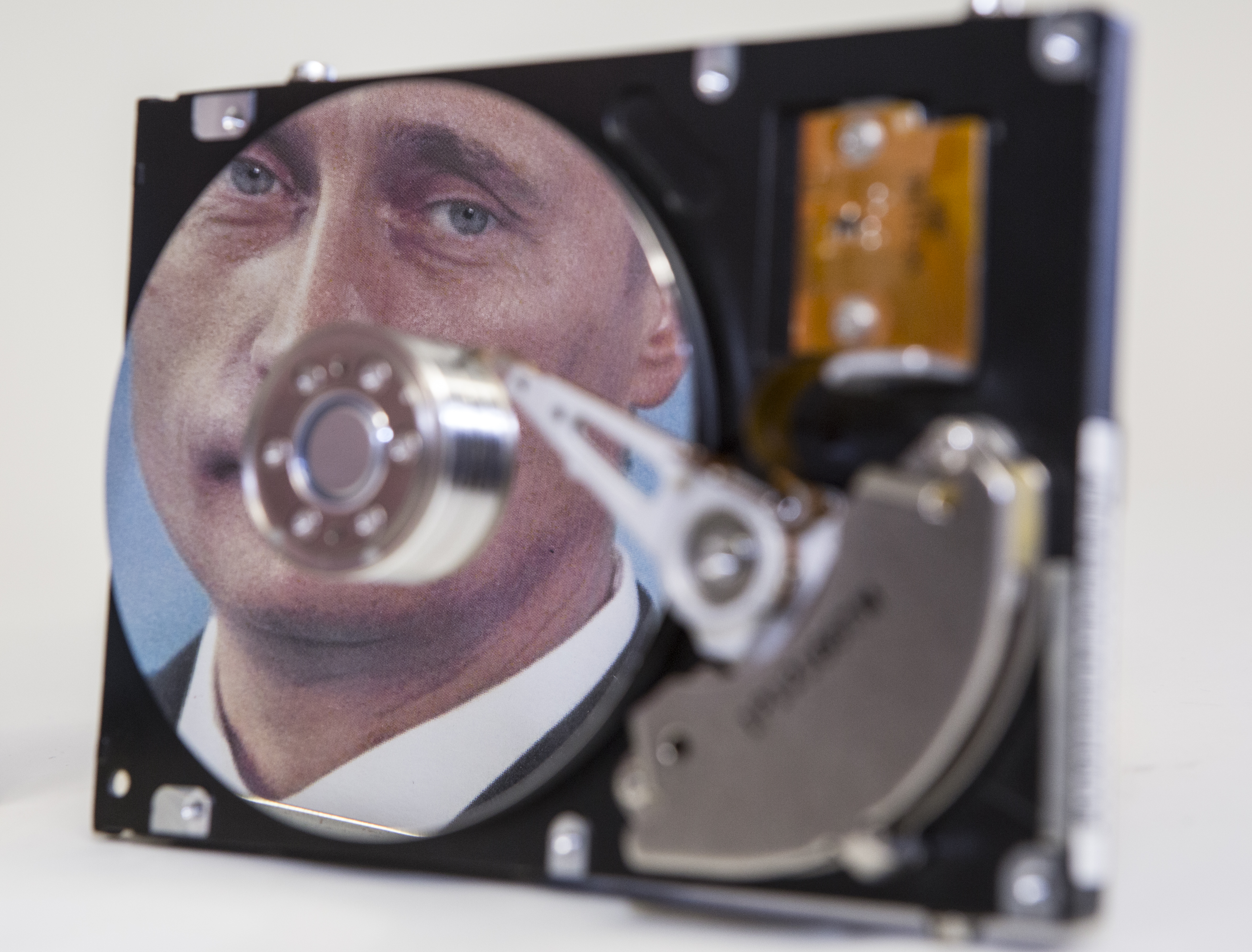 Putin-portrait reflected in a computer hard-drive.