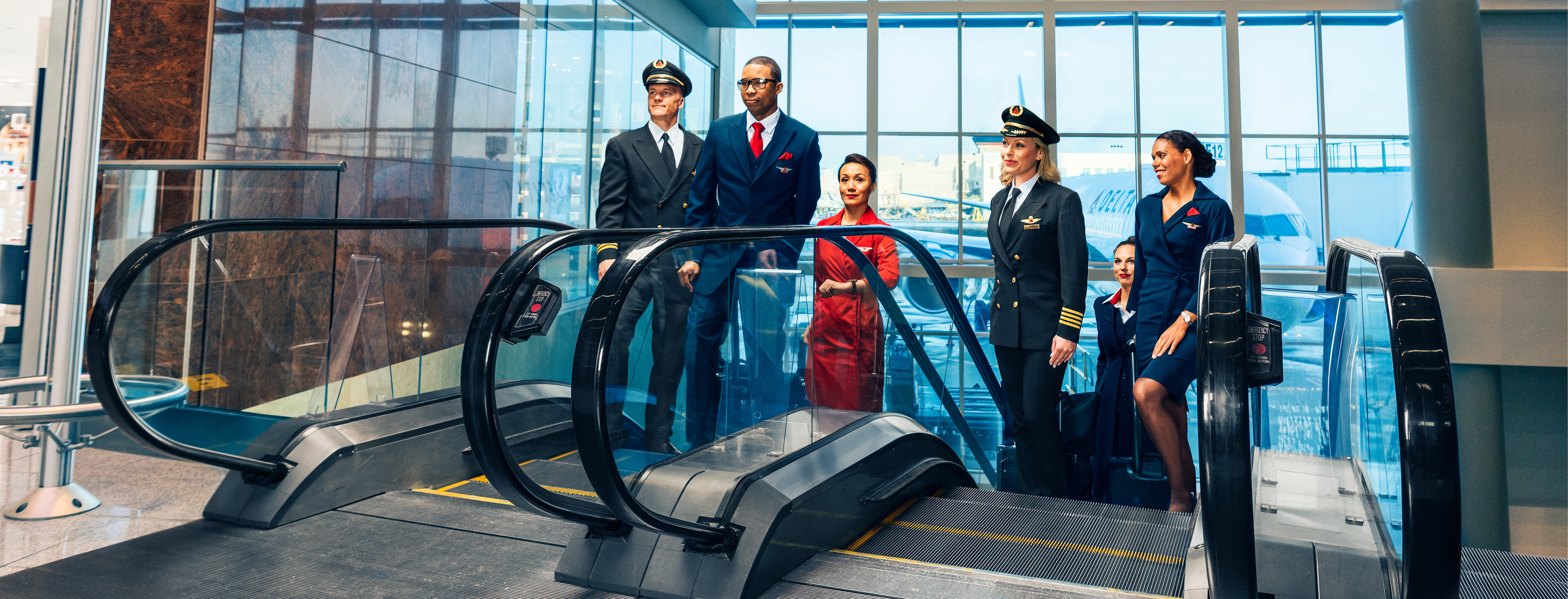 Pilots and Flight Attendants ascending up the escalators. - These images are protected by copyright. Delta has acquired permission from the copyright owner to the use the images for specified purposes and in some cases for a limited time. If you have been authorized by Delta to do so, you may use these images to promote Delta, but only as part of Delta-approved marketing and advertising. Further distribution (including proving these images to third parties), reproduction, display, or other use is strictly prohibited.