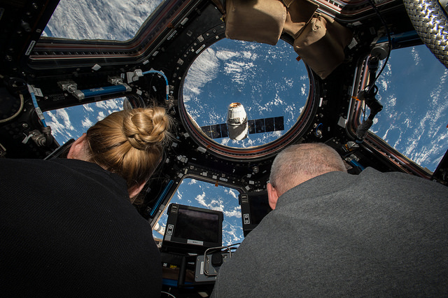 NASA astronauts Kate Rubins (left) and Jeff Williams (right) prepare to grapple the SpaceX Dragon supply spacecraft from aboard the International Space Station. The nearly 5,000 pounds of supplies and equipment