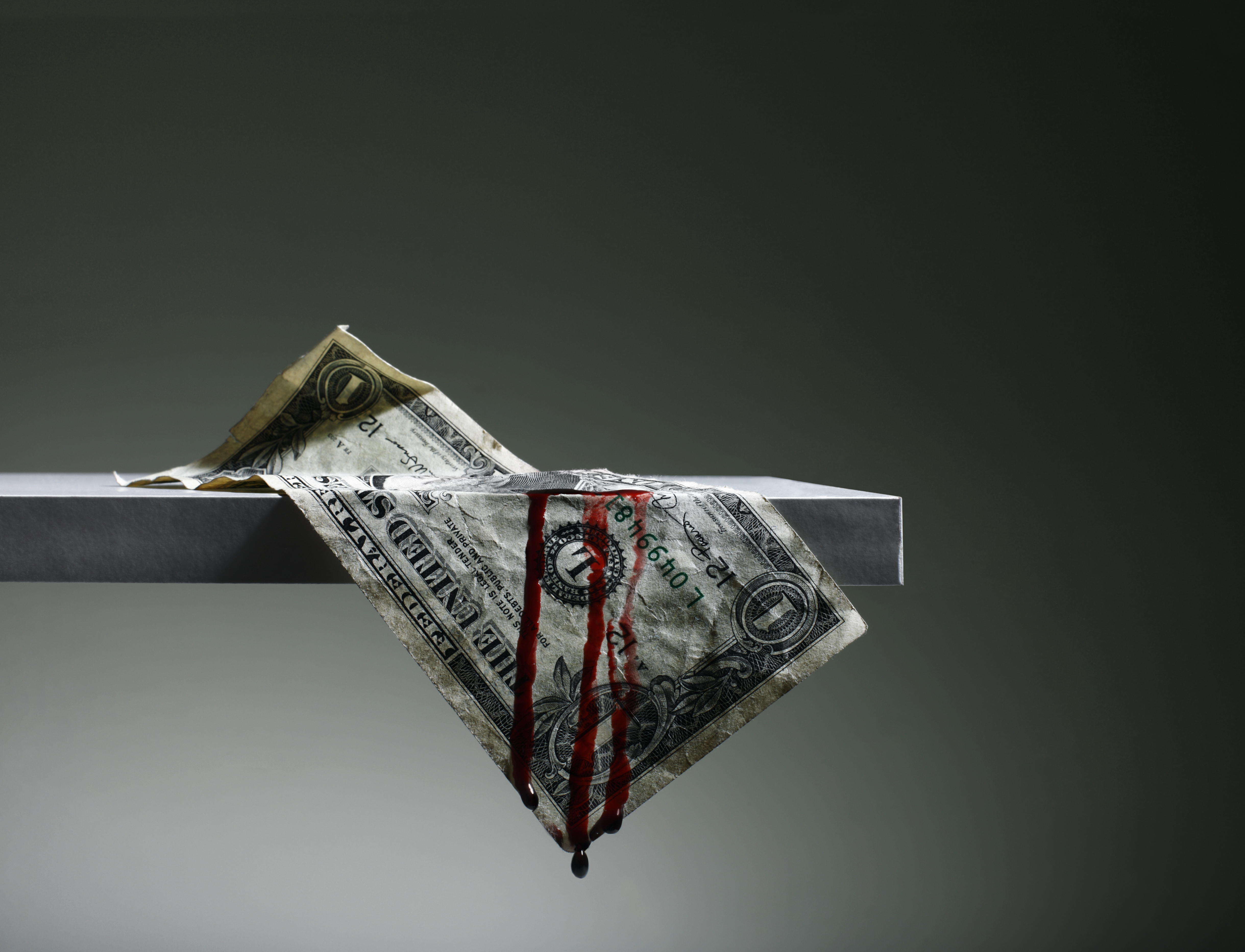US Dollar hanging from Shelf Bleeding