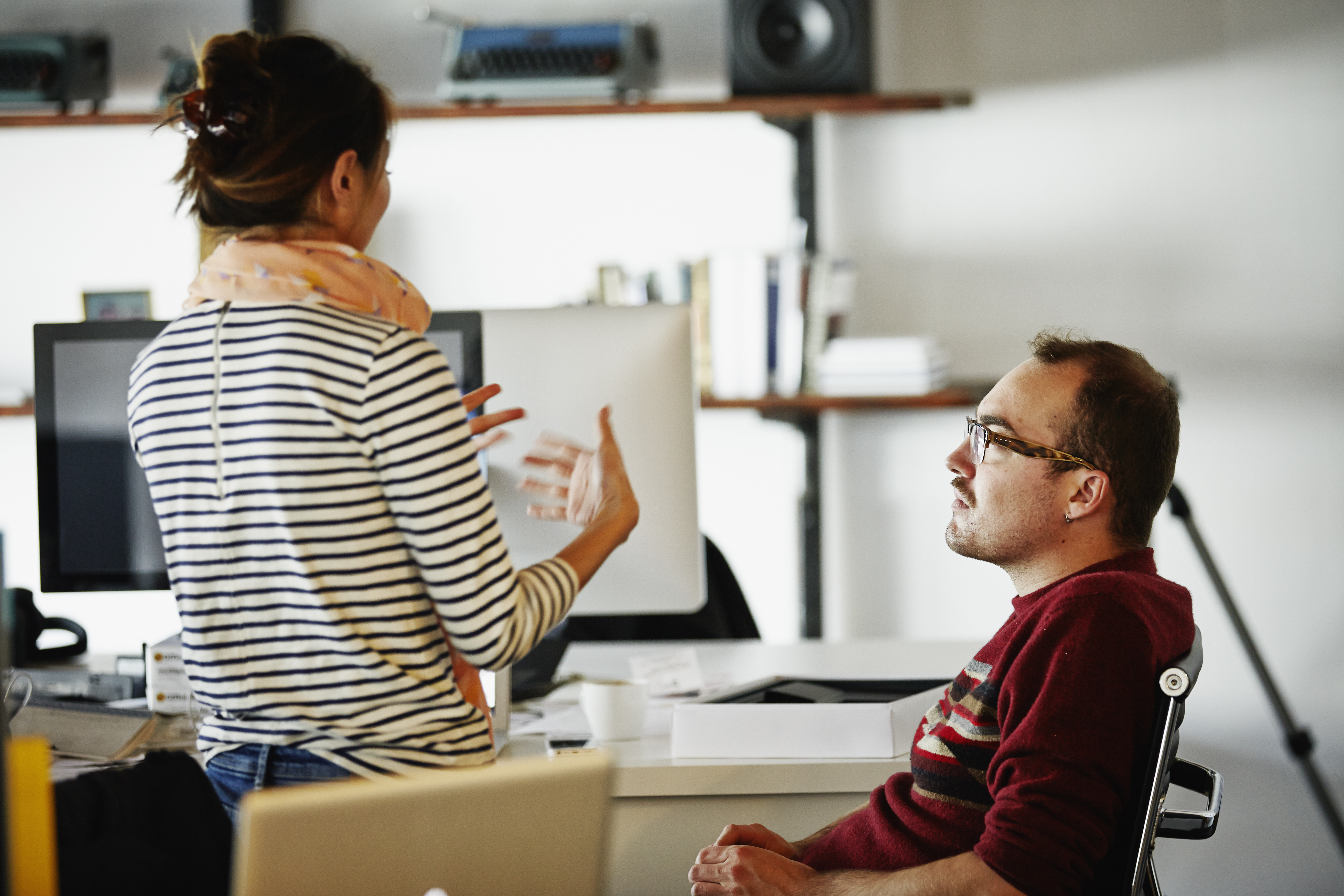 Coworkers discussing project in startup office