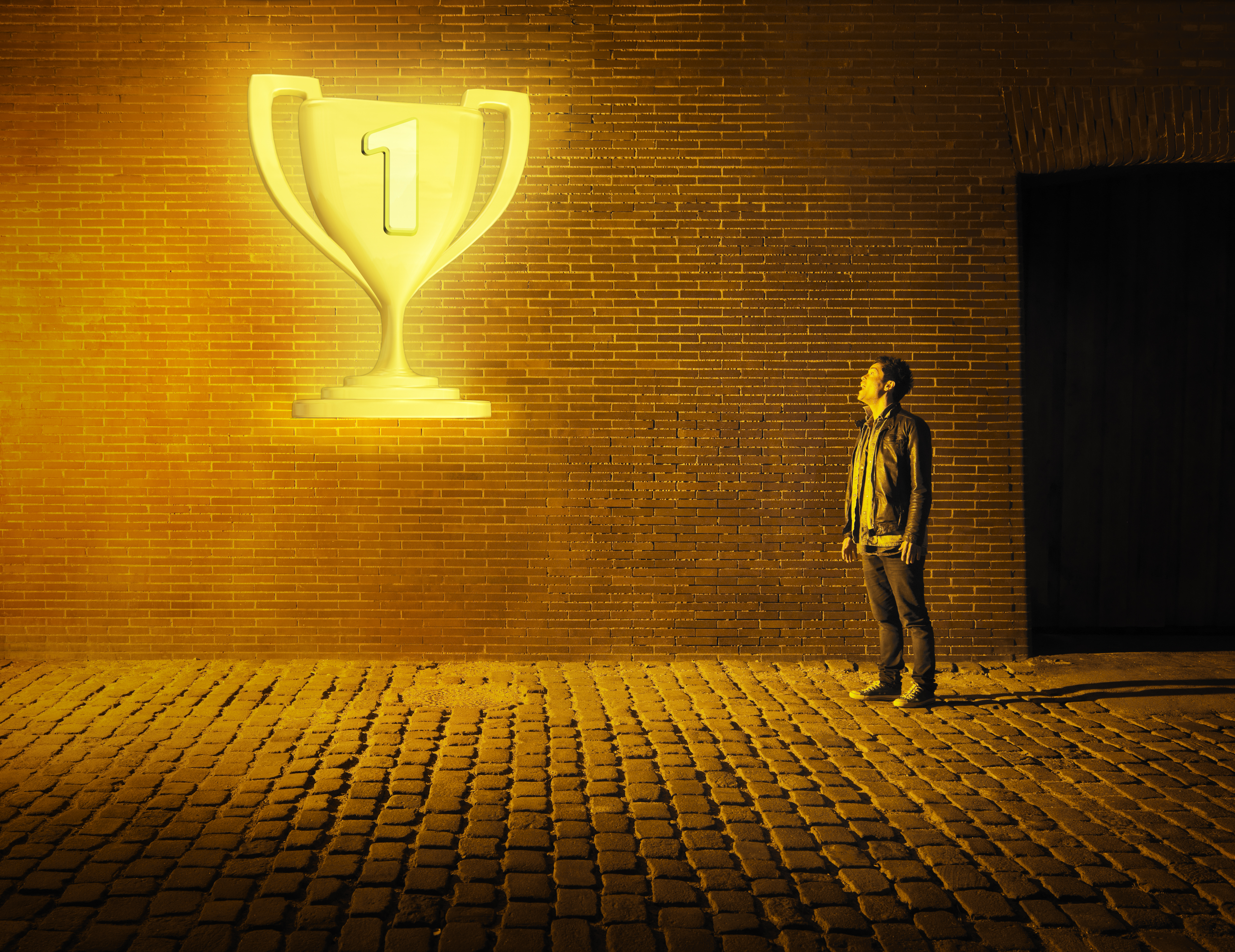 young man looking at glowing tropy