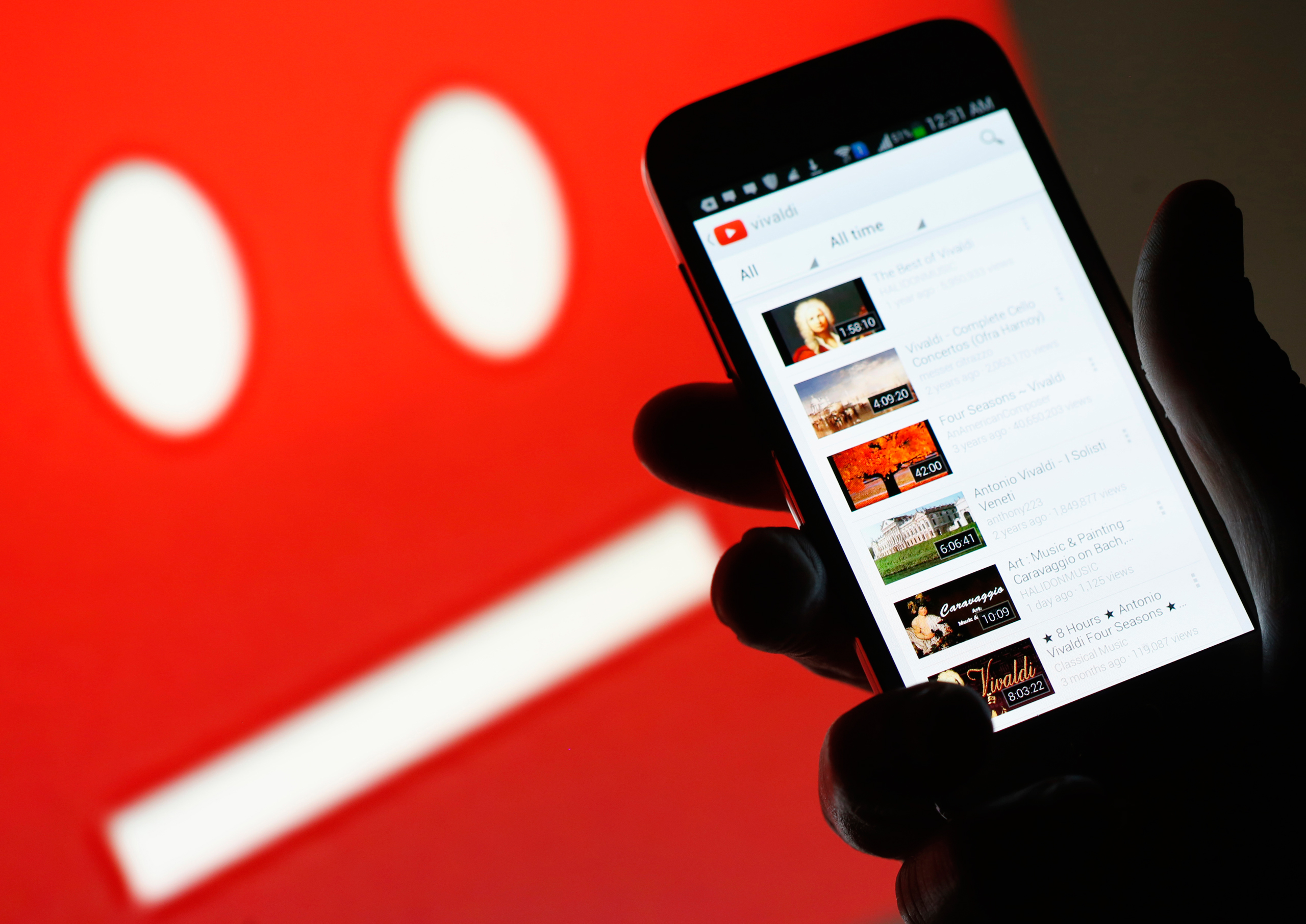 A picture illustration shows YouTube on a cell phone, in front of a YouTube copyright message regarding a video on an LCD screen, in central Bosnian town of Zenica