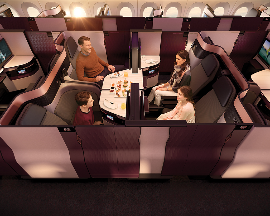 In the newest business class configuration rolled out by Qatar Airways, two pairs of adjacent seats can be turned into a private suite for four.