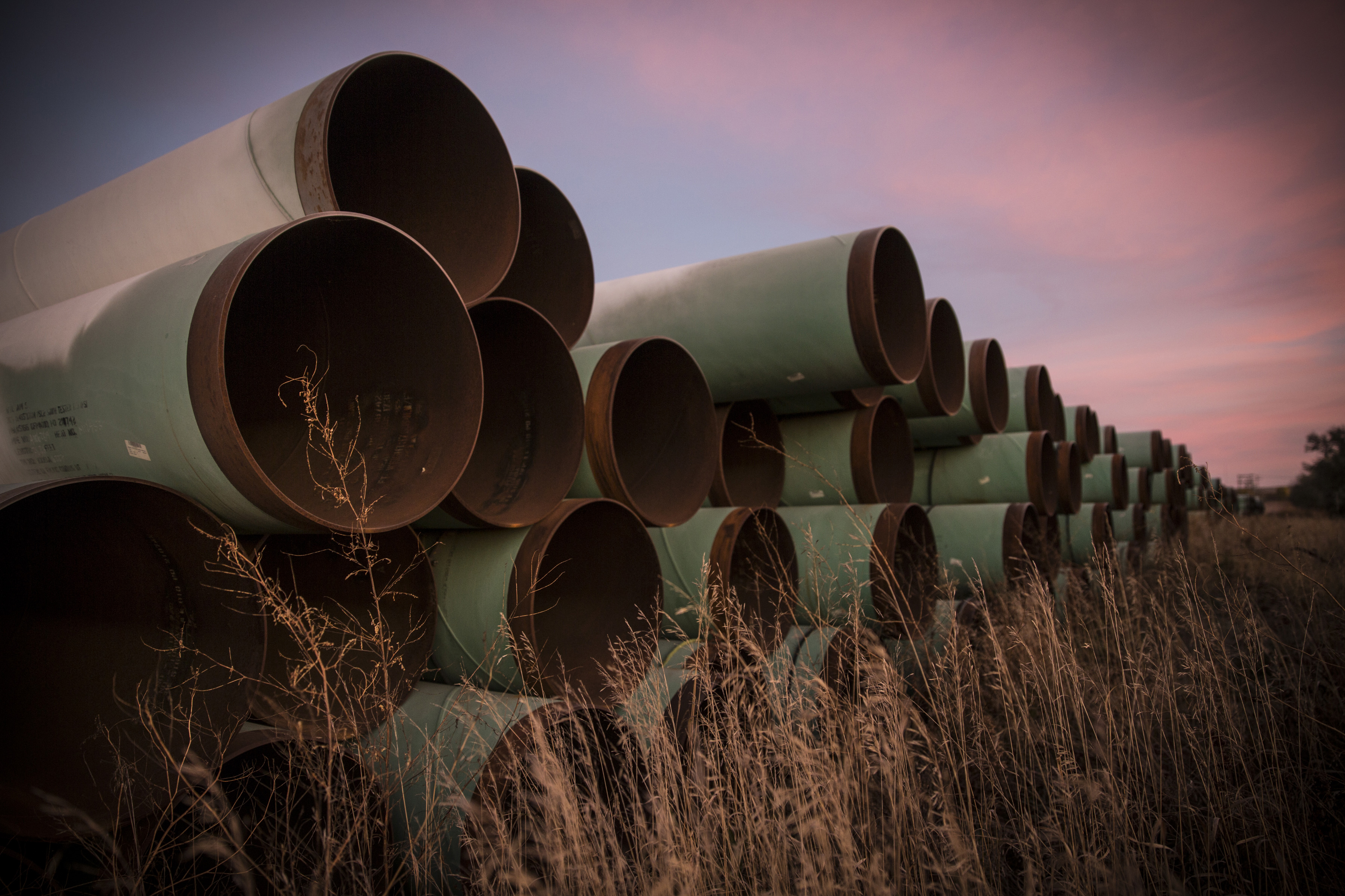 Miles of unused pipe, prepared for the proposed Keystone XL pipeline, sit in a lot on October 14, 2014 outside Gascoyne, North Dakota.