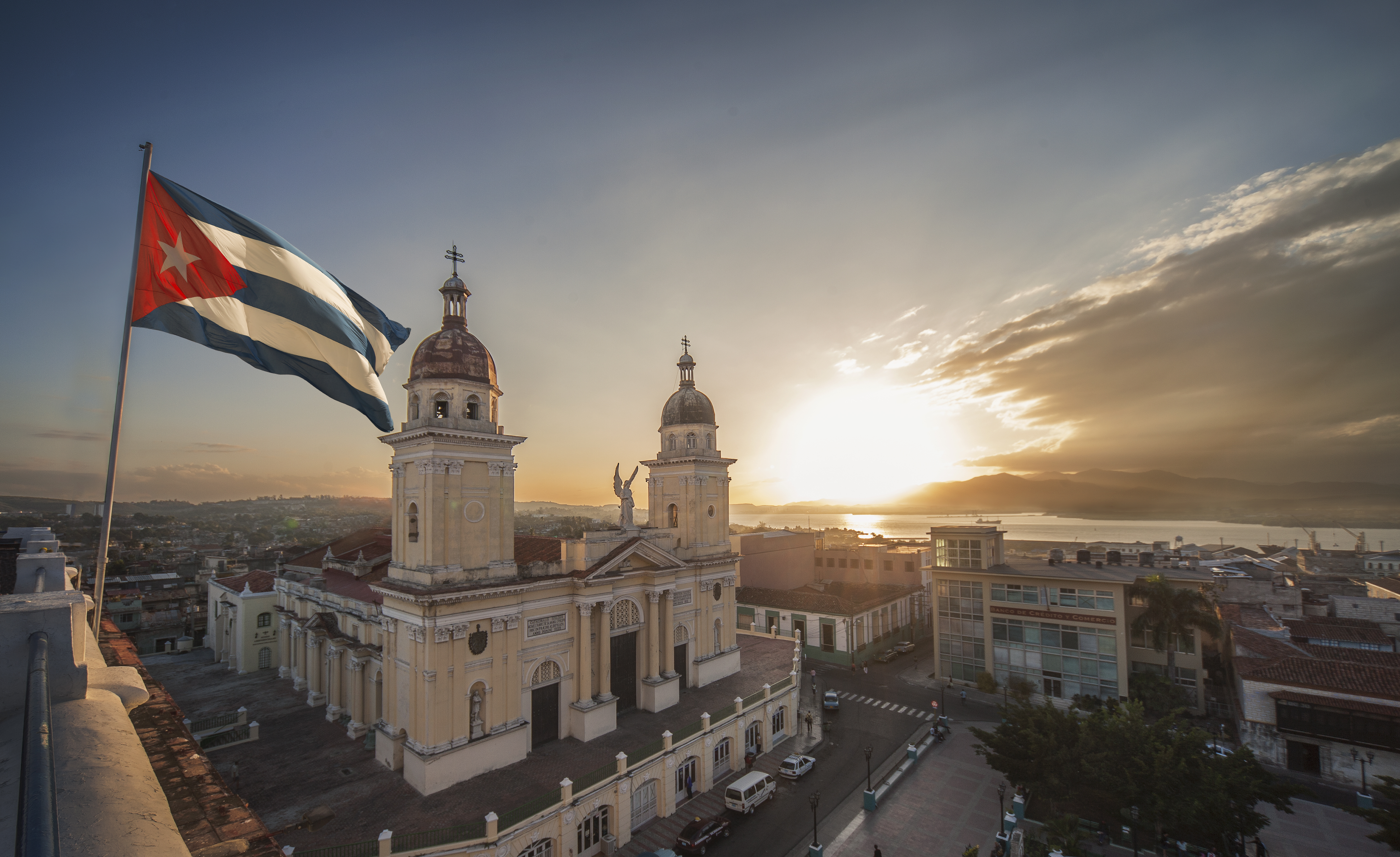 Cuban flag over Plaza de la Cathedral at sunset, Santiago de Cuba, Cuba
