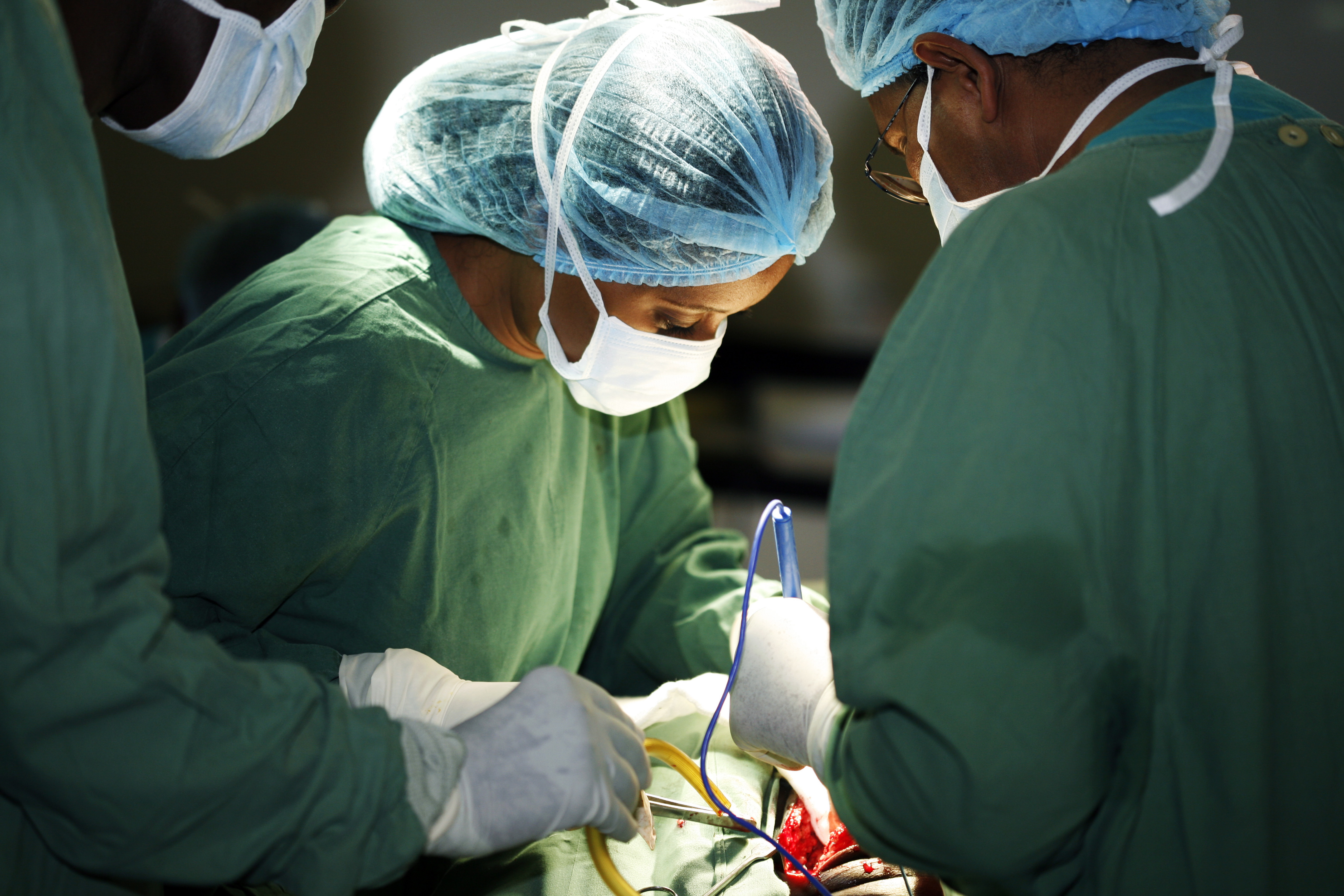Female surgeon and her assistants operating on patient.