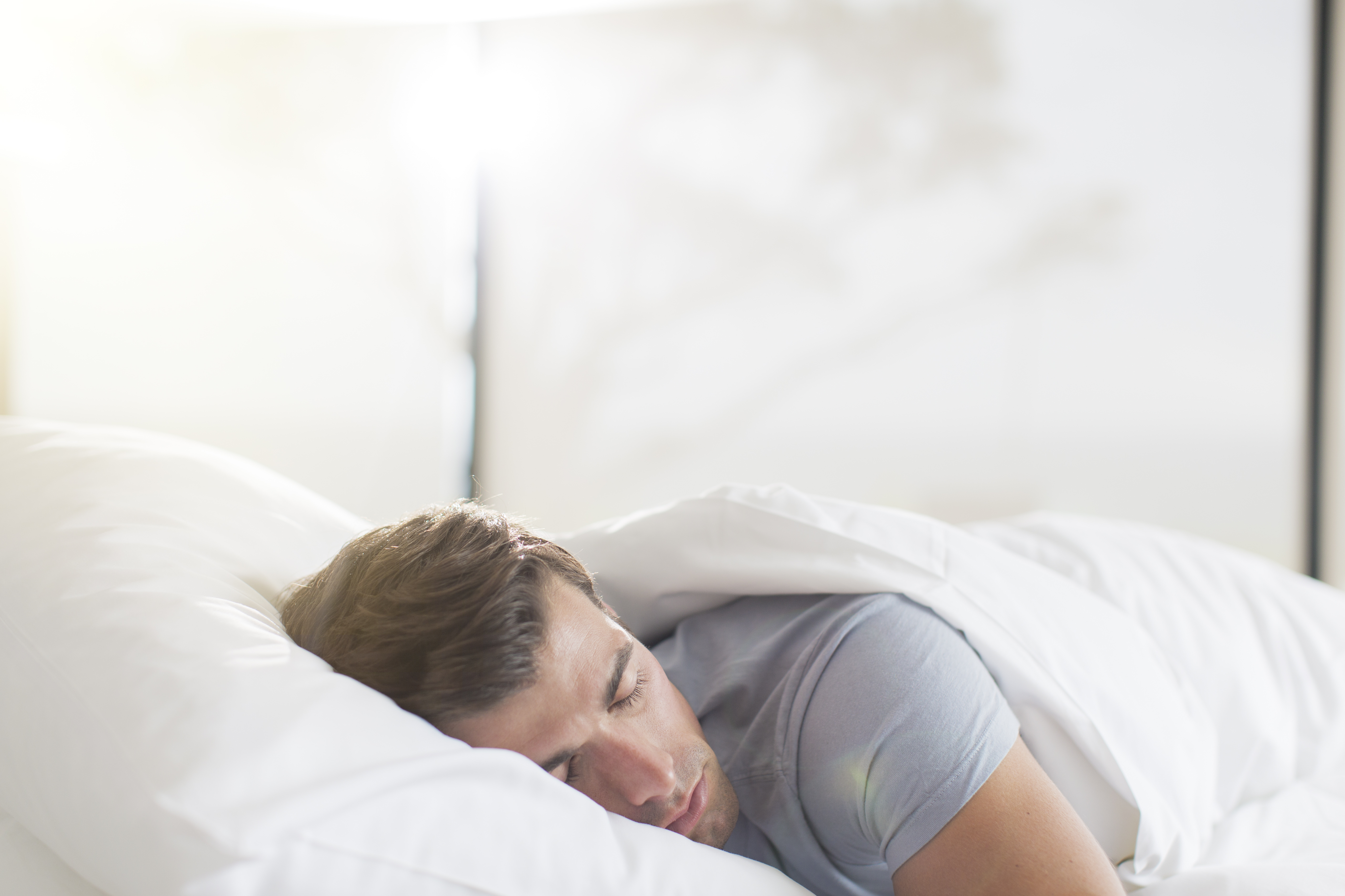 Young man sleeping in bed