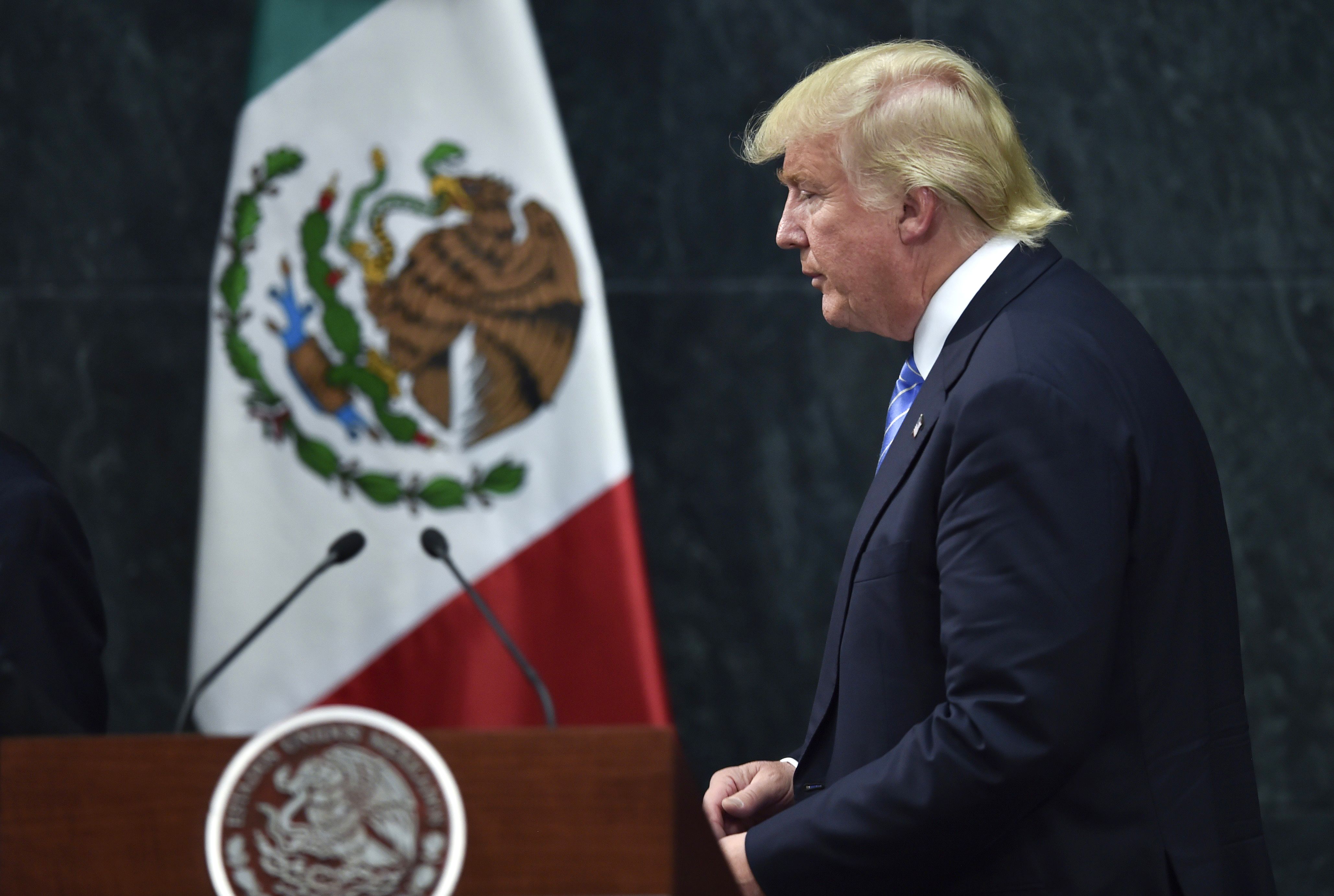 Donald Trump leaves a joint press conference with Mexican President Enrique Peña Nieto in Mexico City on August 31, 2016.