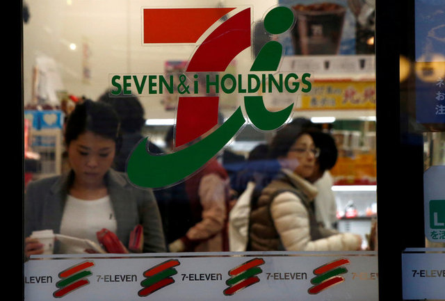 FILE PHOTO: People are seen at Seven & i Holdings Co's Seven Eleven convenience store in Tokyo