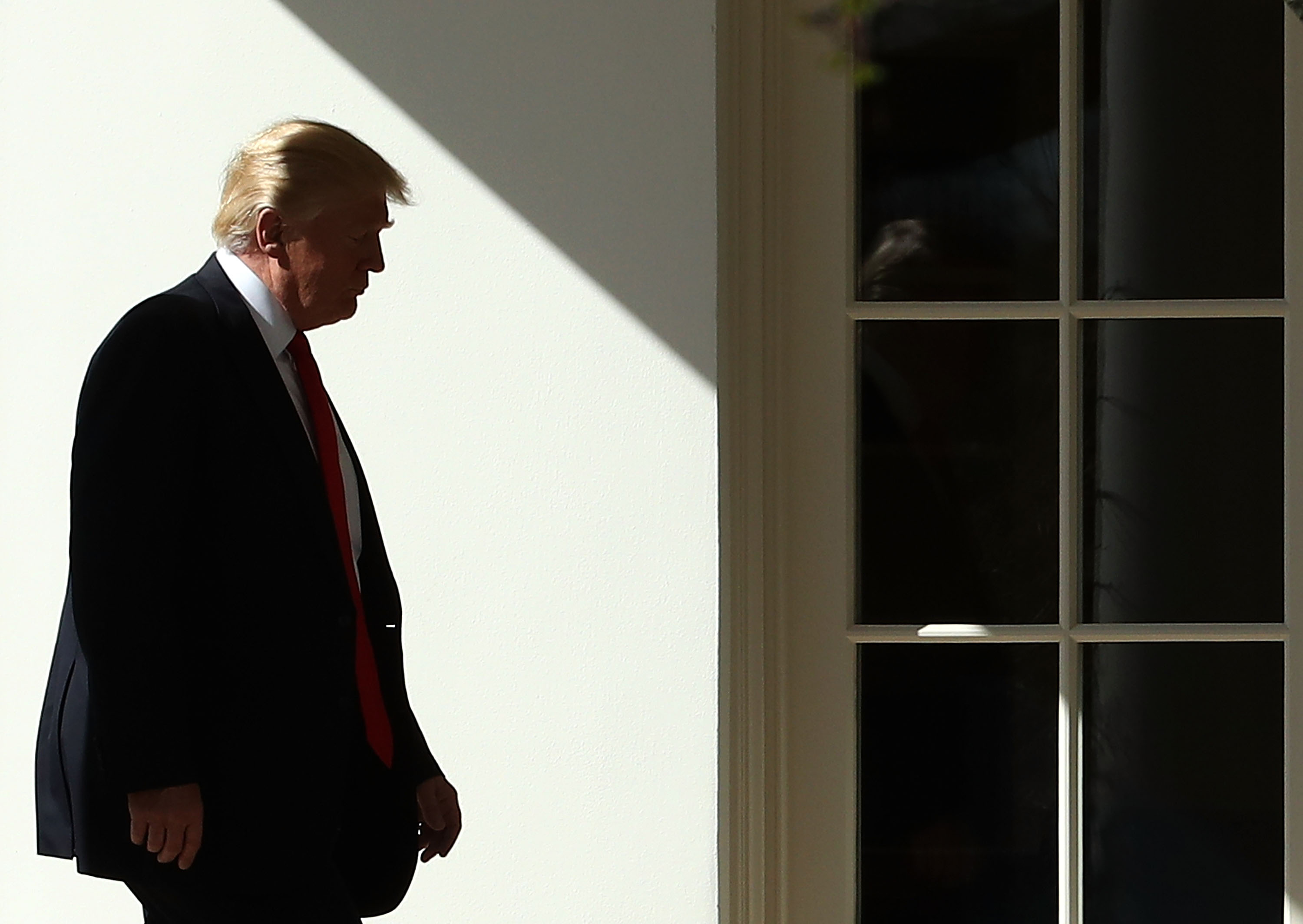 President Donald Trump walks to the Oval Office in February.
