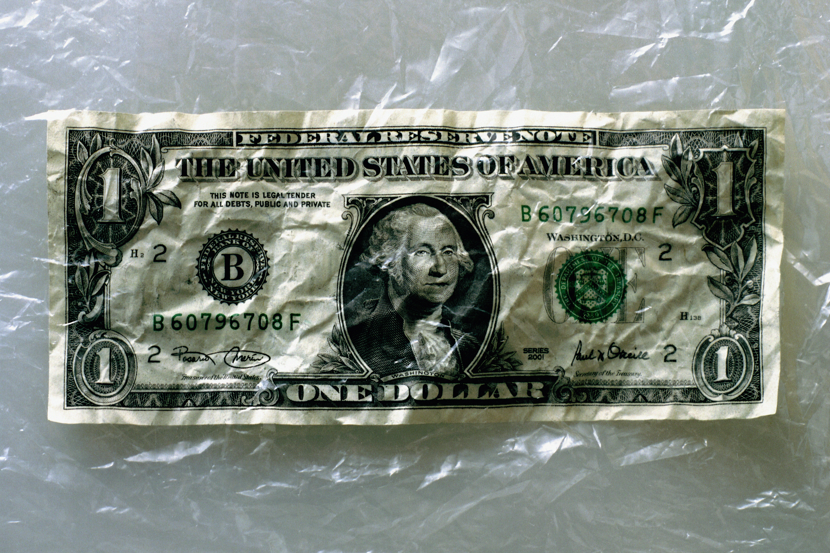 US currency: crumpled one dollar bill