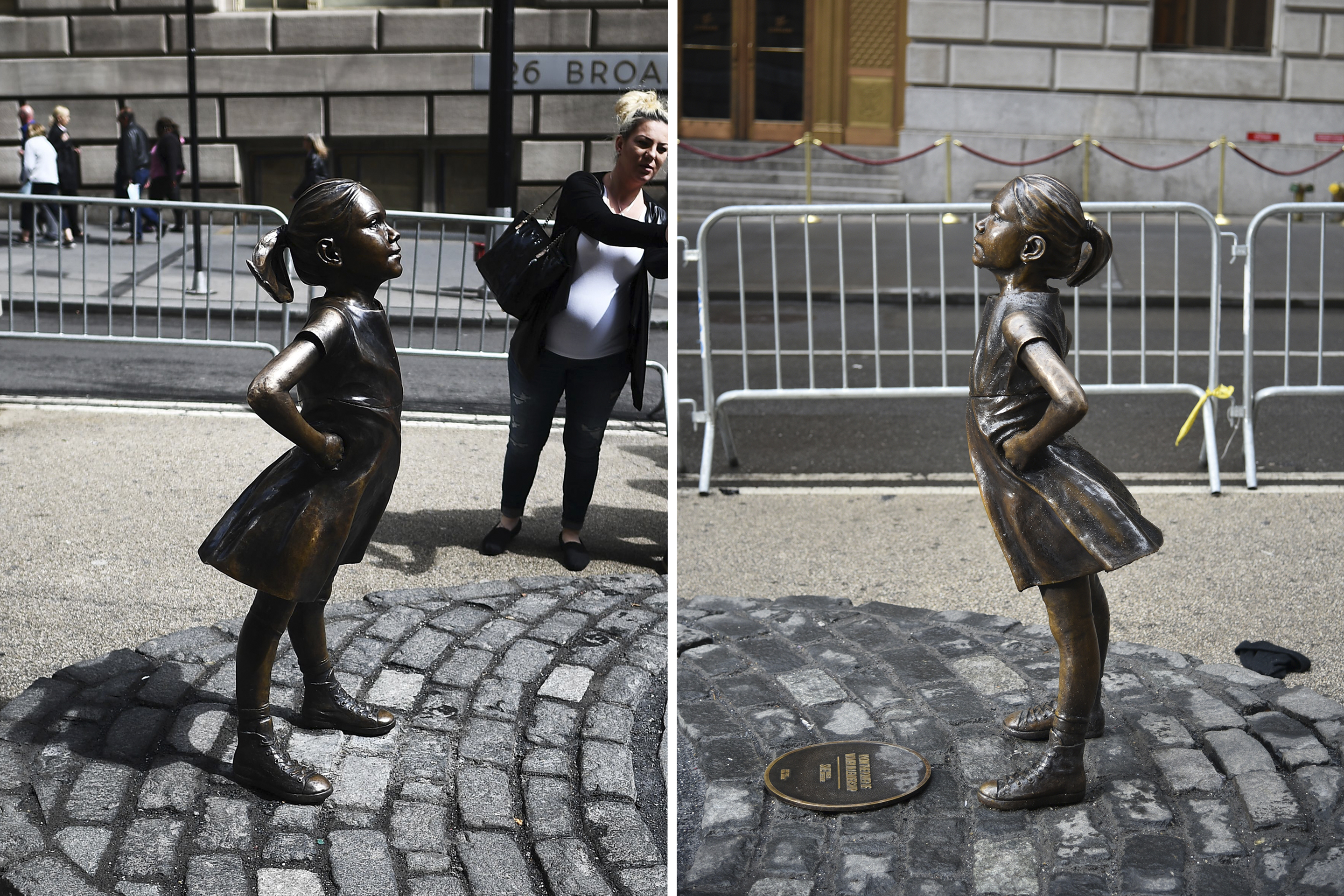 The "Fearless Girl" statue faces Wall Street's charging bull statue, Wednesday, March 28, 2017, in New York. The statue was installed by investment firm State Street Global Advisors to highlight efforts to get more women on corporate boards. An inscription at the base reads, "Know the power of women in leadership. She makes a difference." (AP Photo/Sean Thompson) The "Fearless Girl" statue stands facing the "Charging Bull" as people take pictures in New York on April 12, 2017.
A battle is heating up between two iconic New York statues, the legendary "Charging Bull" and new kid on the block "Fearless Girl," with gender equality, artistic integrity and copyright issues at stake. The Italian-American artist who created "Charging Bull," which has stood south of Wall Street for nearly 30 years, alleged Wednesday that "Fearless Girl" breached his copyright, distorted his artistic message and should be moved elsewhere.
The work of US artist Kristen Visbal, the bronze "Fearless Girl" was installed last month, standing defiant, hands on hips and chin jutting out, directly challenging the bull.
/ AFP PHOTO / Jewel SAMAD (Photo credit should read JEWEL SAMAD/AFP/Getty Images)