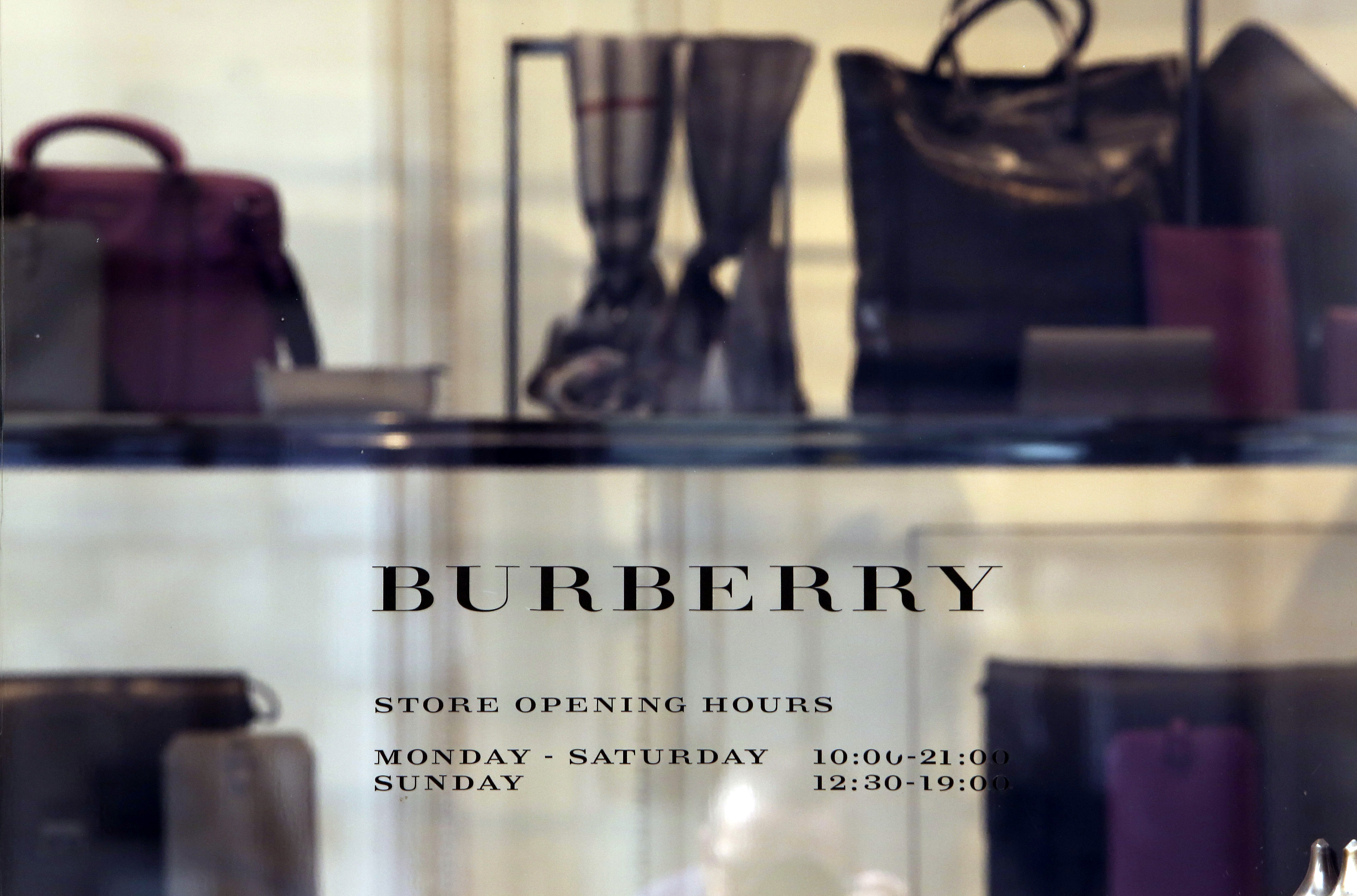 Burberry Group Plc Stores And Apple Inc. Logos As Apple Poach Burberry's Ahrendts