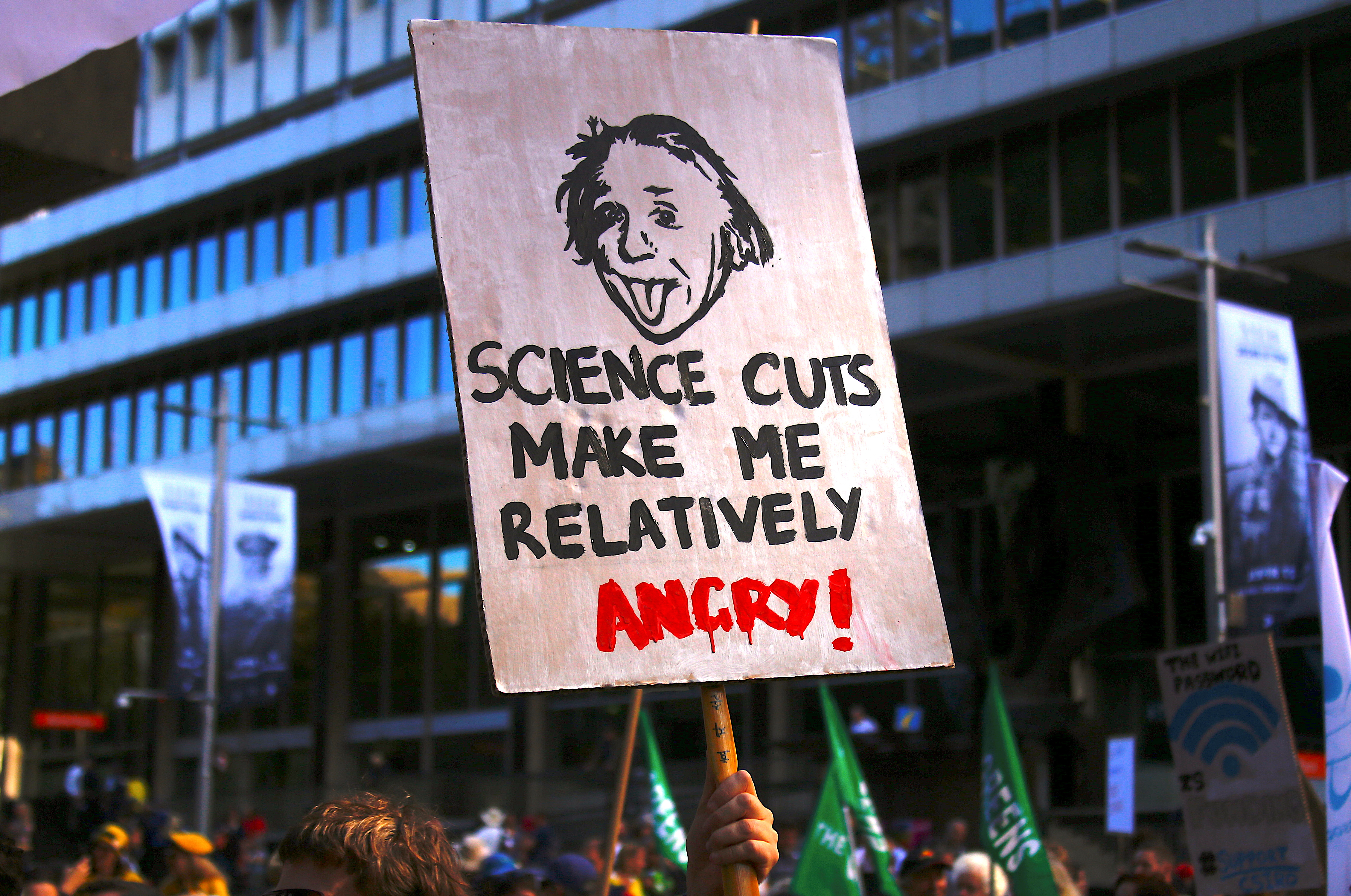 Protesters hold placards and banners as they participate in the March for Science rally on Earth Day, in central Sydney