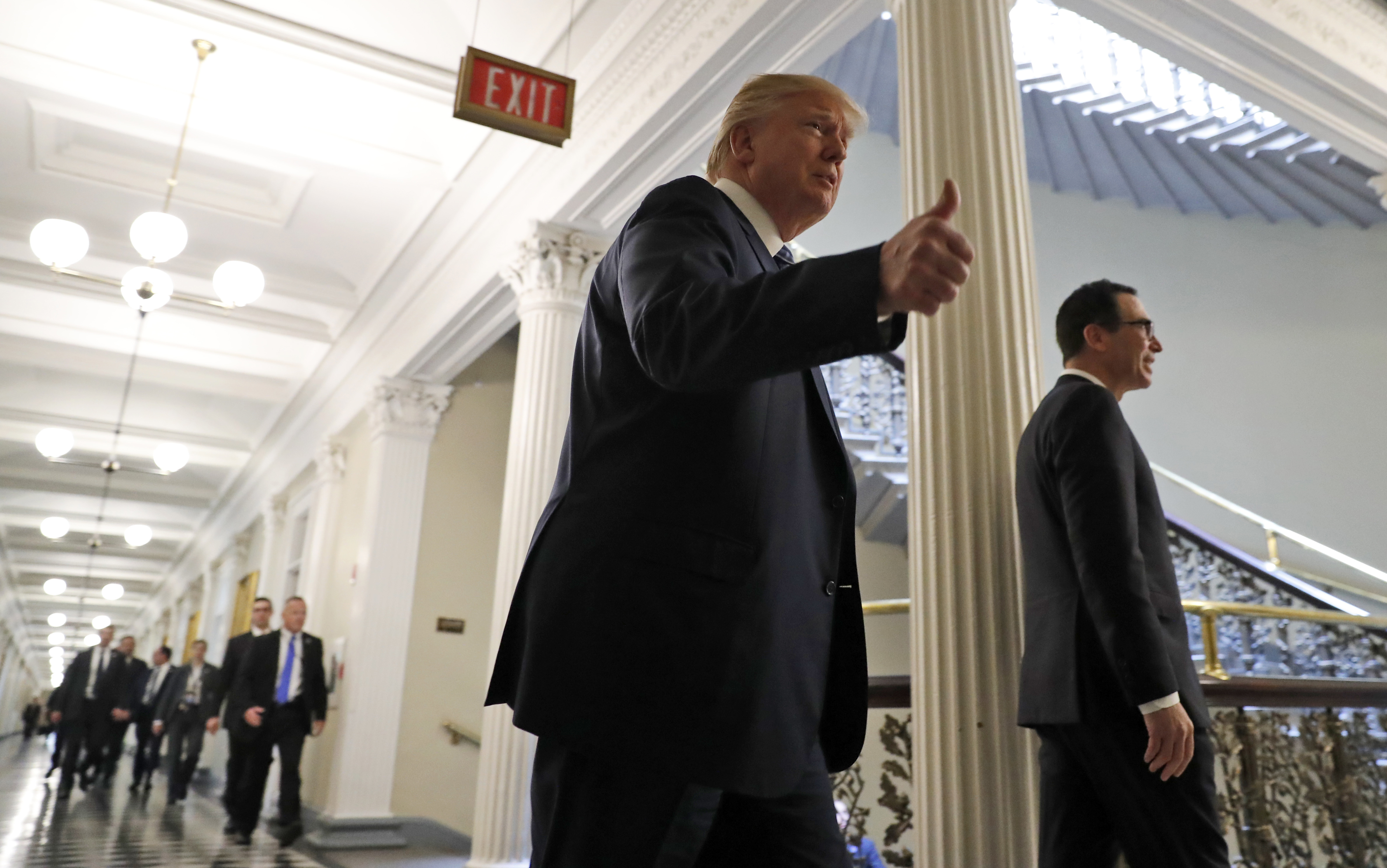 President Donald Trump, accompanied by Treasury Secretary Steve Mnuchin, at the Treasury Department in Washington, Friday, April 21