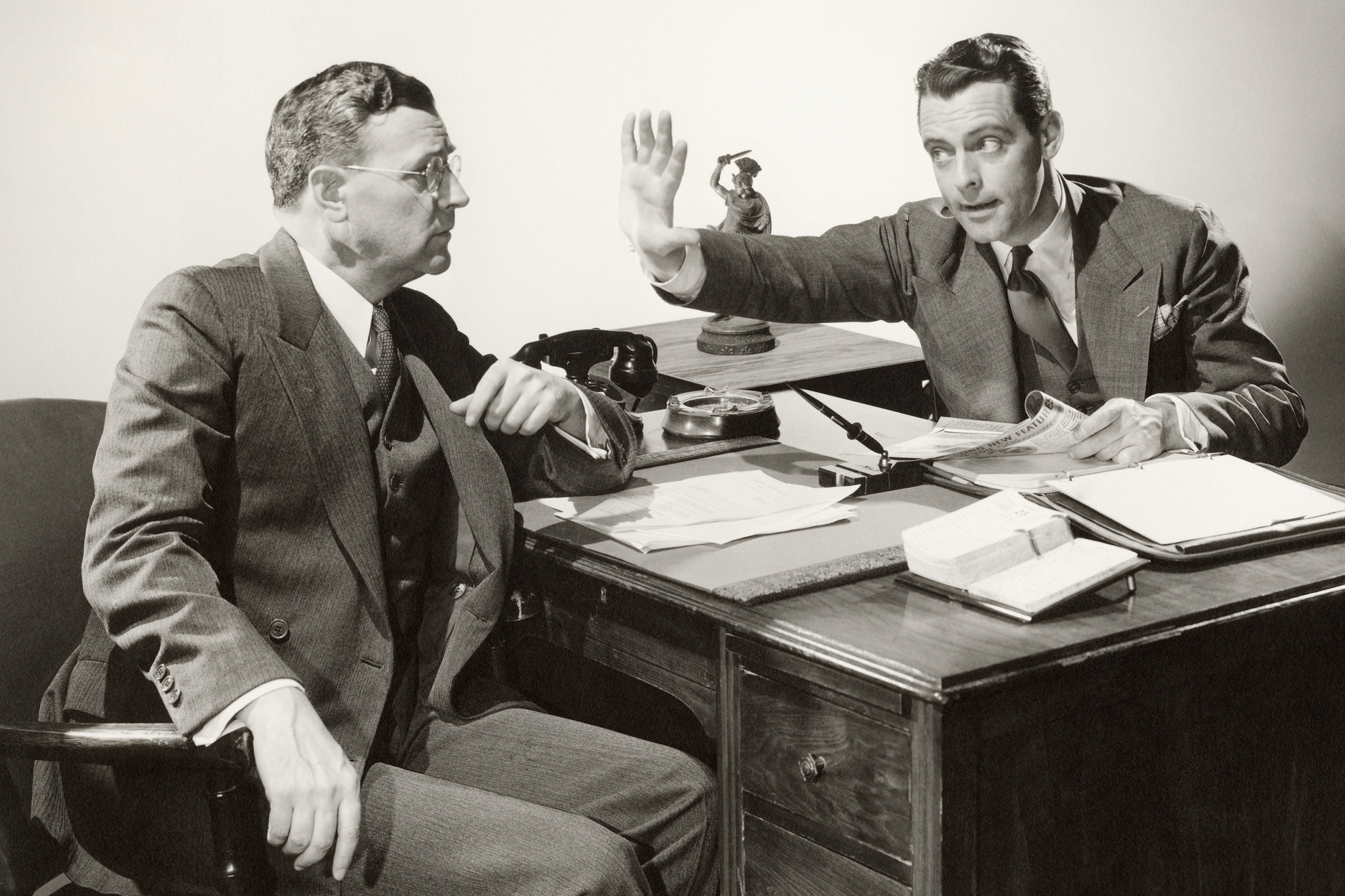 Arguing businessmen at meeting