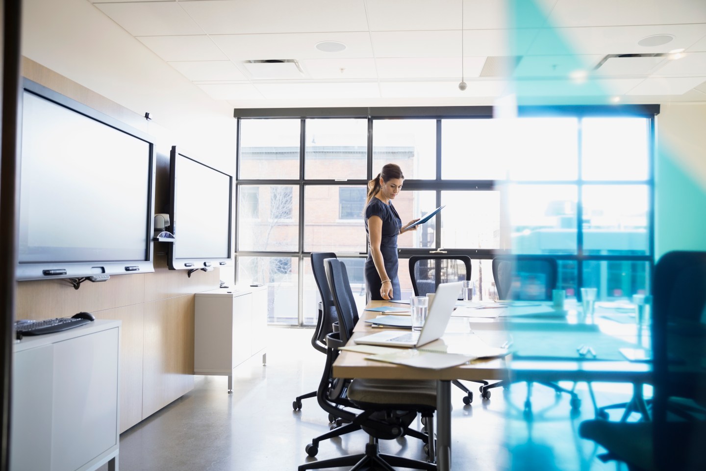 Businesswoman preparing for meeting in conference room