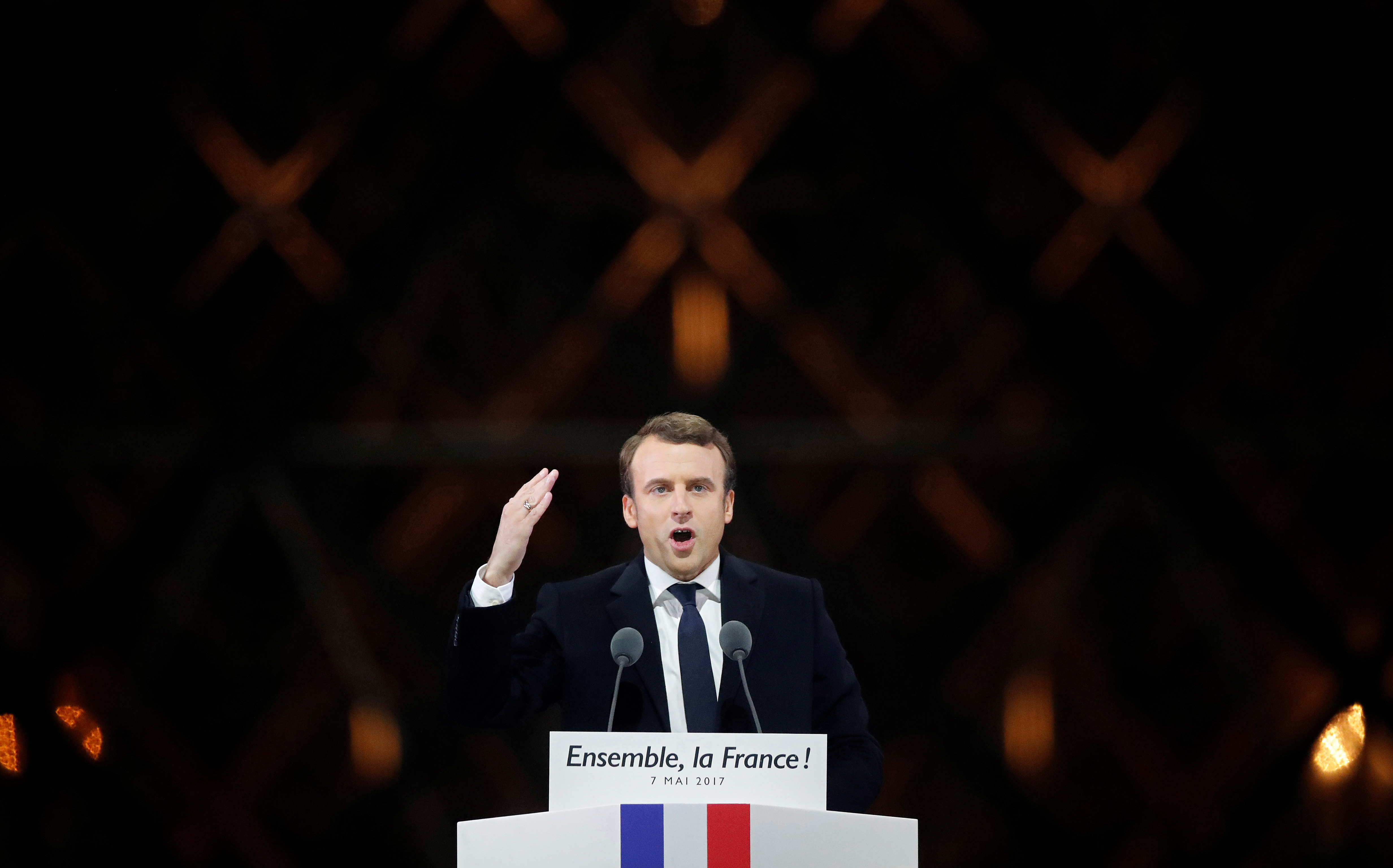 French President-elect Emmanuel Macron celebrates on the stage at his victory rally near the Louvre in Paris