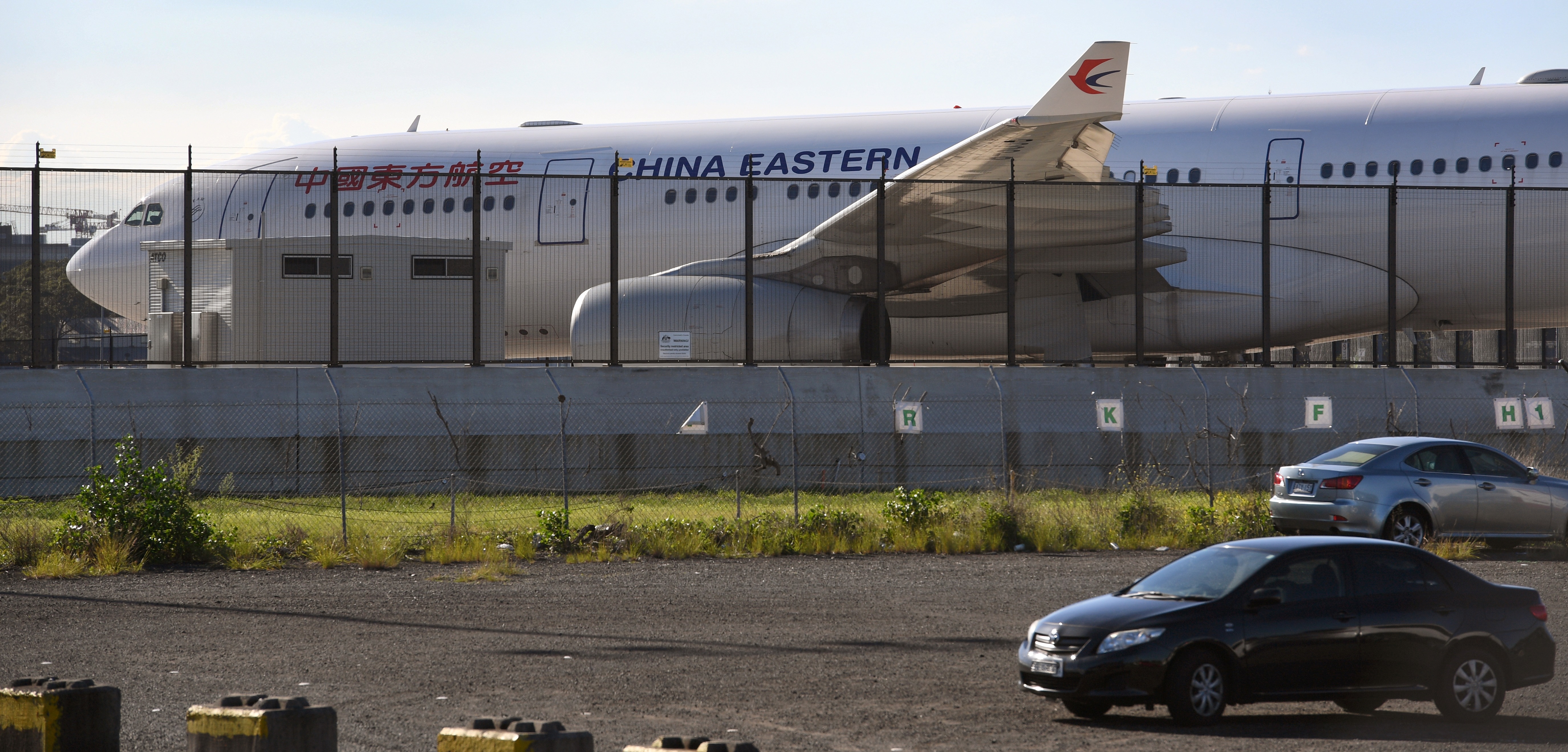 A China Eastern Airbus A330 passenger aircraft, which suffered a serious fault to its starboard engine following take-off, sits on the tarmac at Sydney Airport on June 12, 2017.