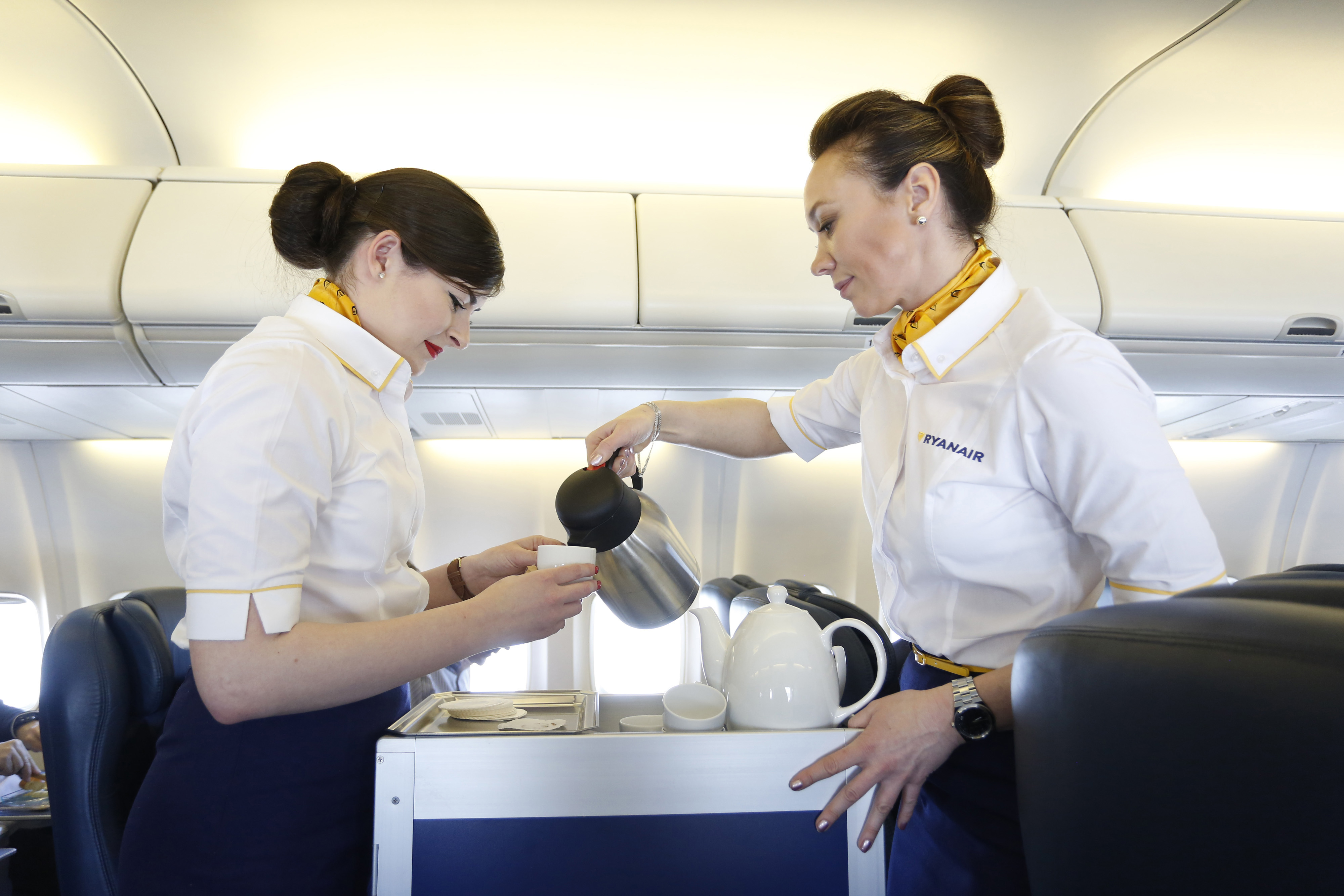 Air stewardesses serve coffee in the cabin of the Ryanair Holdings Plc corporate jet during a flight to Dublin, Ireland, on April 12, 2016.
