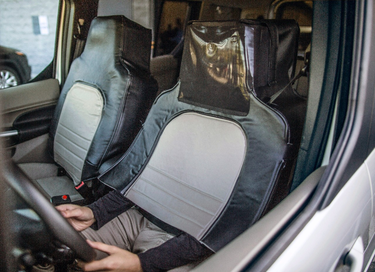 A man disguises himself as a car seat to observe people's reactions