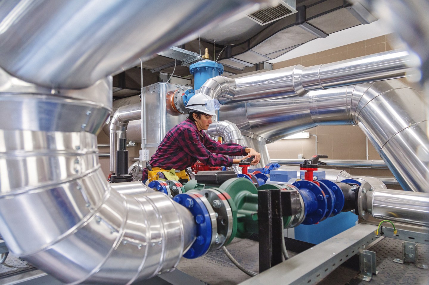 Technician working on valve in factory or utility