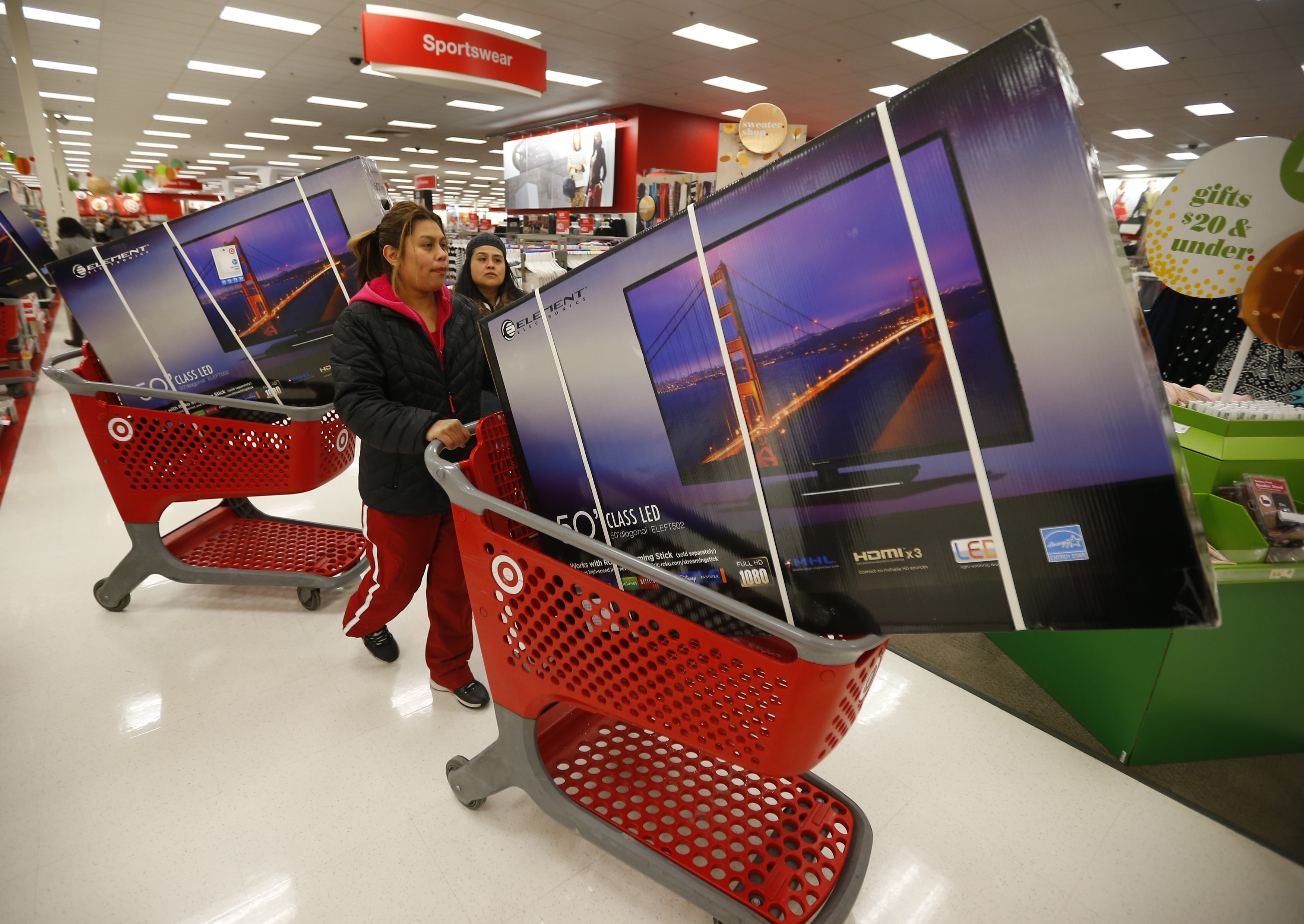 Thanksgiving Day holiday shoppers line up with discounted television sets at the Target retail store in Chicago