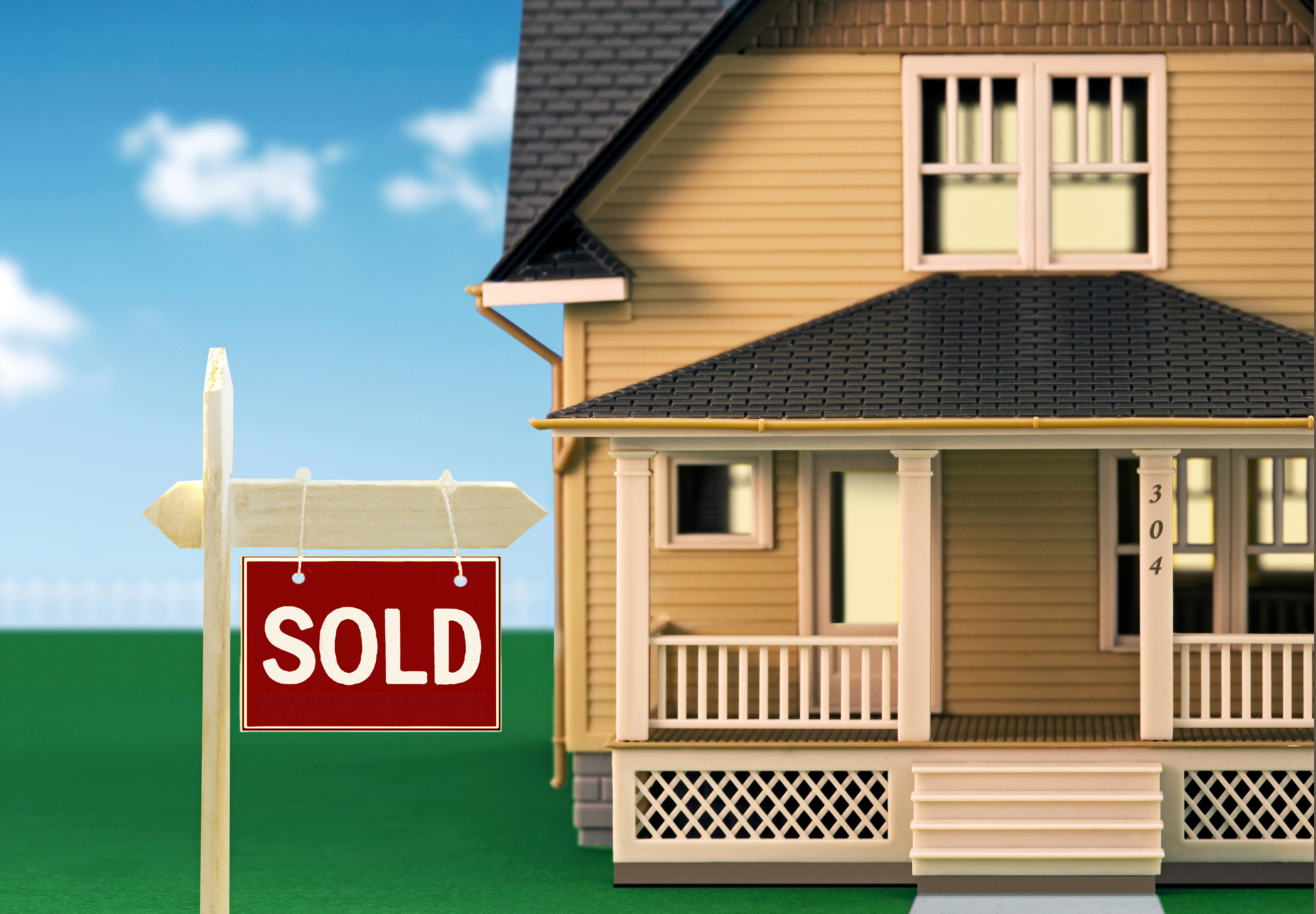 Sold sign in front of model houses