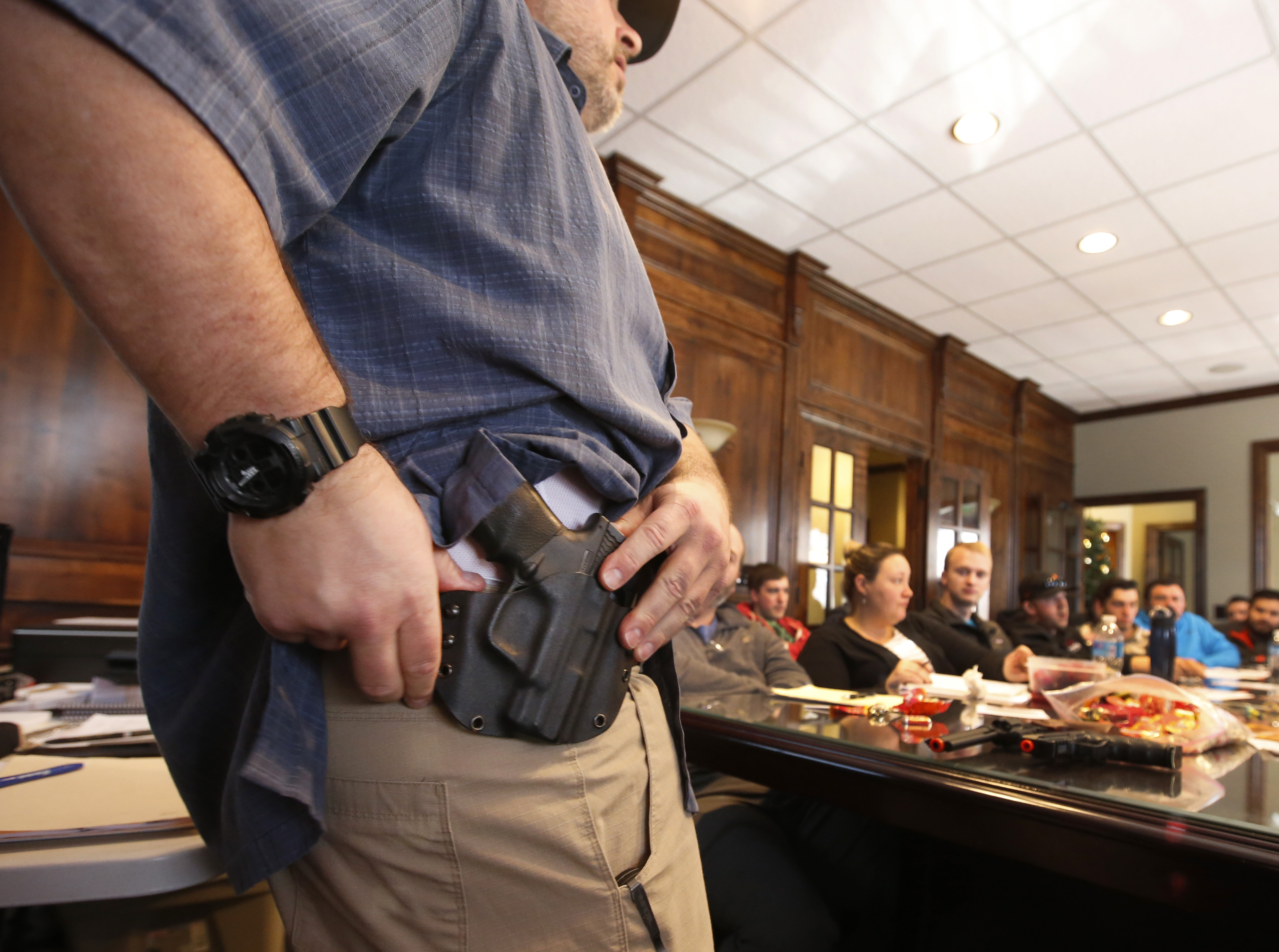 Damon Thueson shows a holster at a gun concealed carry permit class put on by "USA Firearms Training" on December 19, 2015 in Provo, Utah.