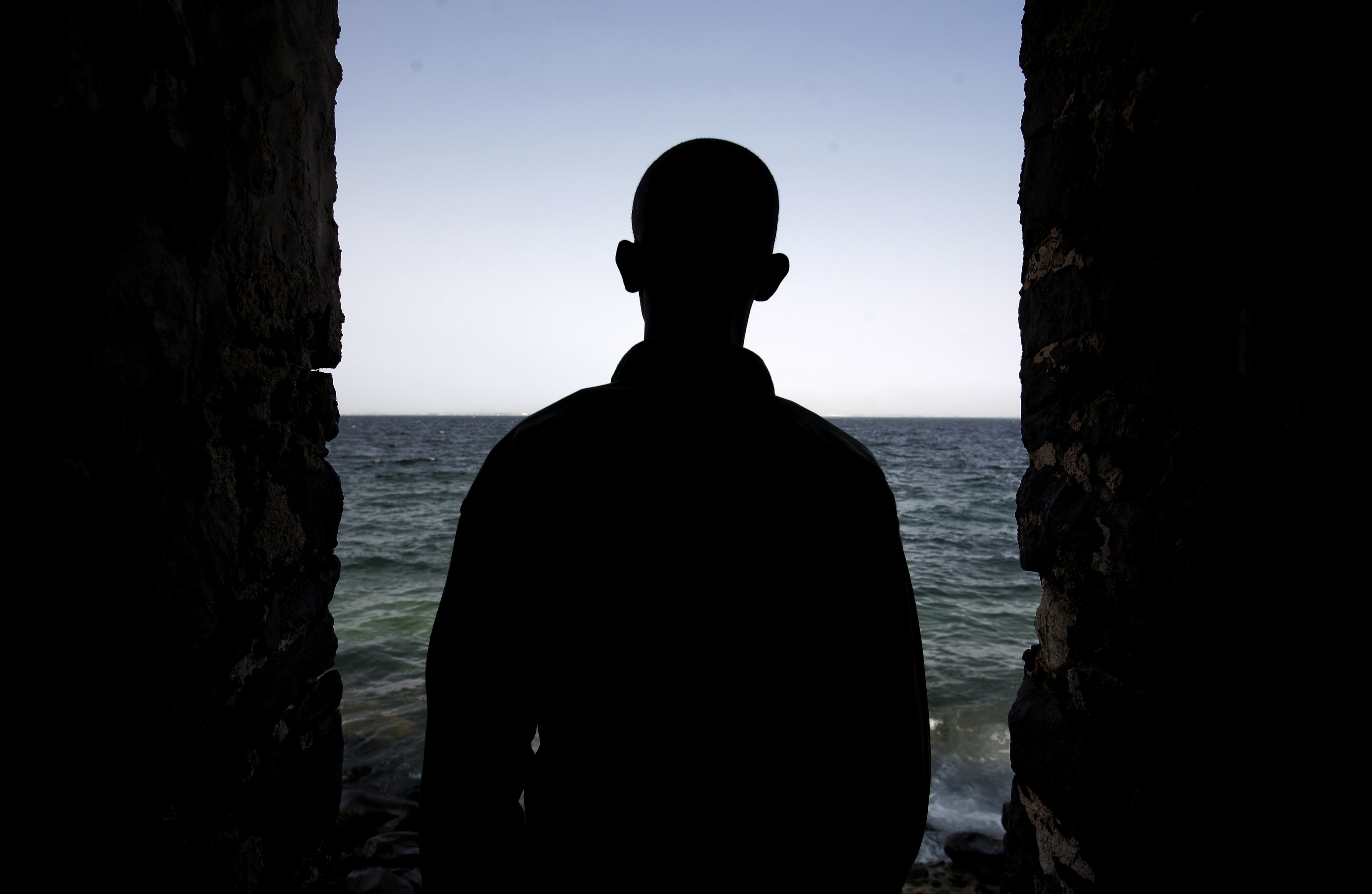 A man is silhouetted in the "Door of No Return" at the House of Slaves on Goree Island near Senegal's capital Dakar