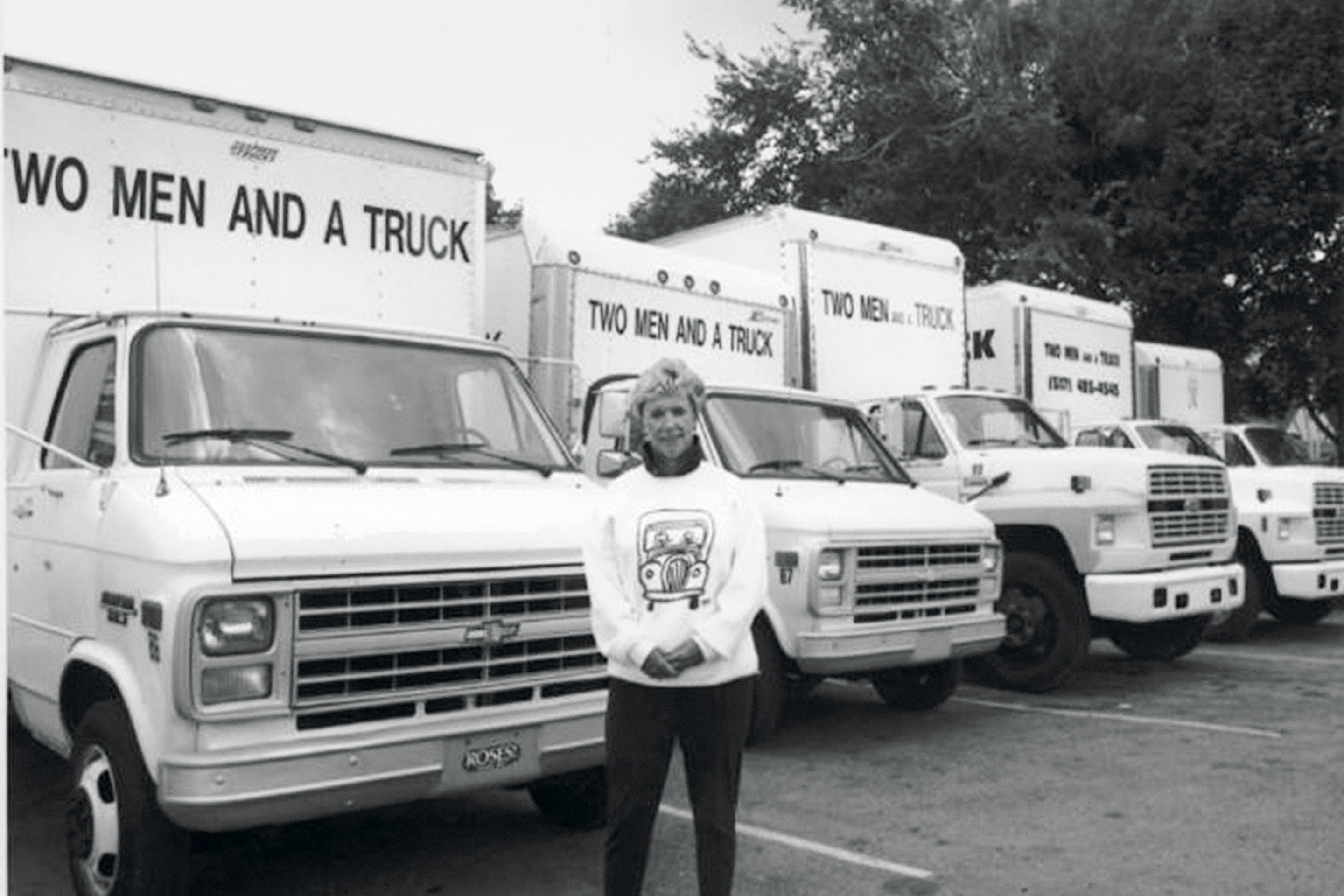 Mary Ellen Sheets stands proudly in front of the Two Men and a Truck fleet in Lansing in 1991.