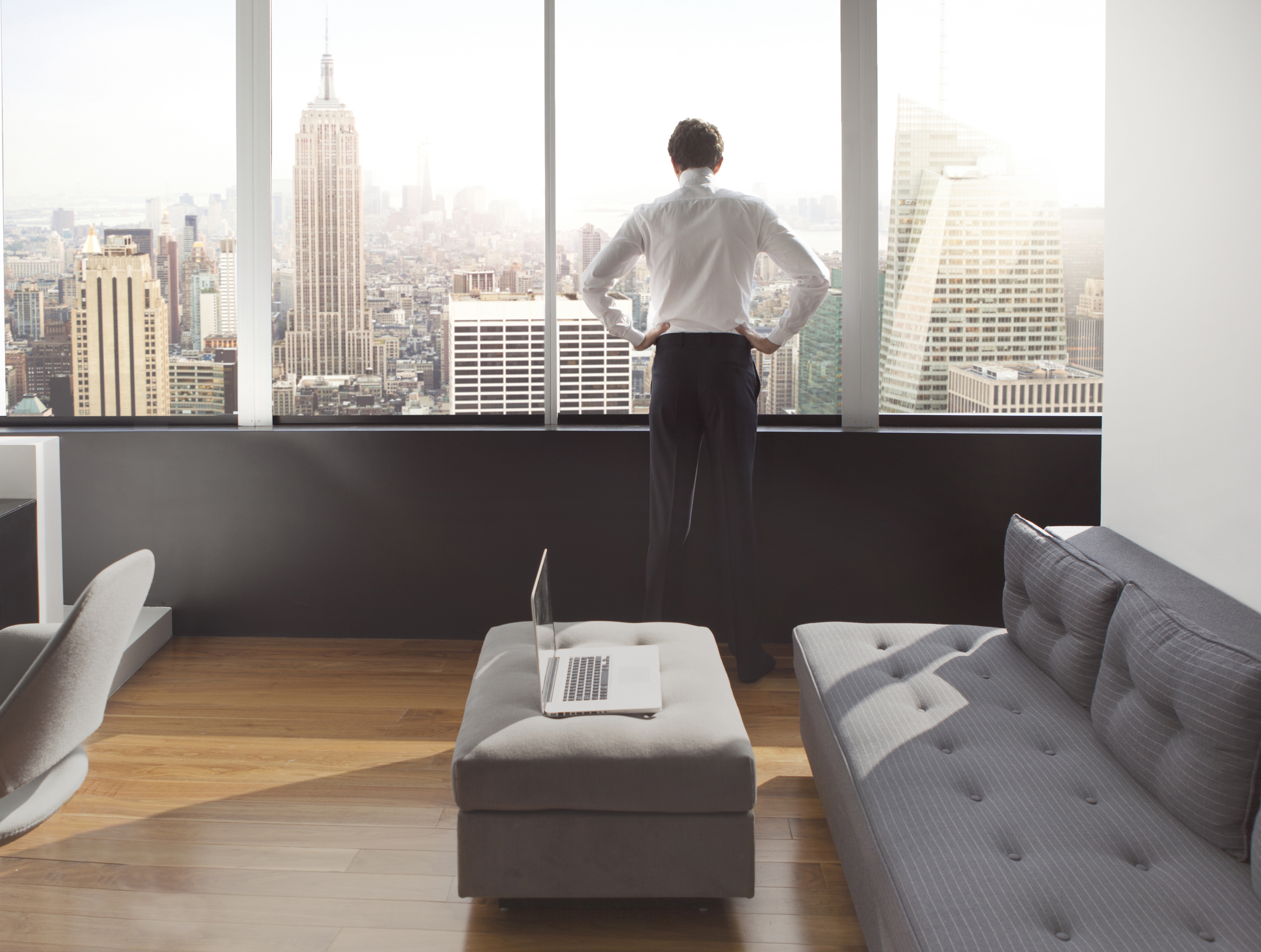 Young man looking out at city skyline