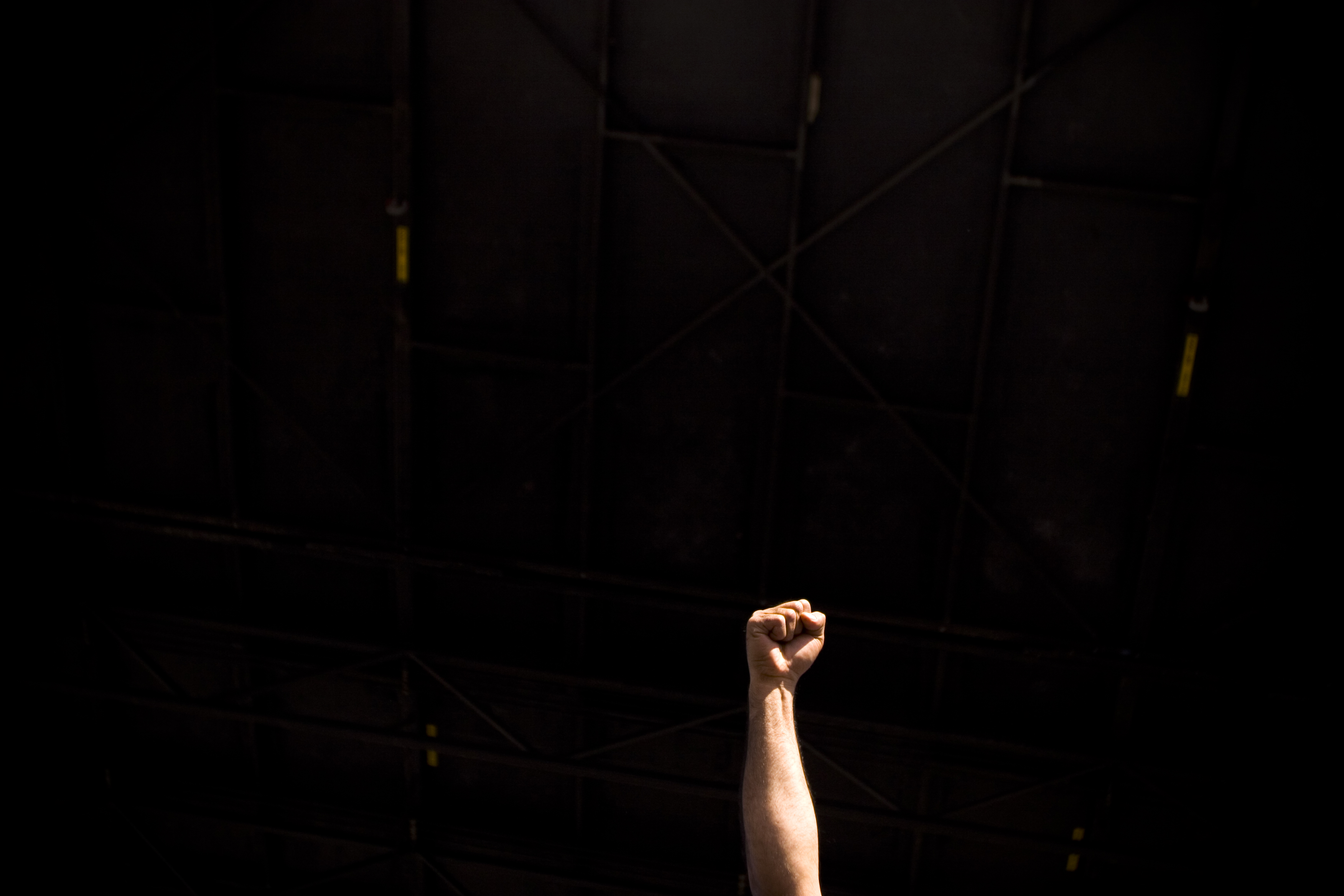 Fist raised in protest against black background