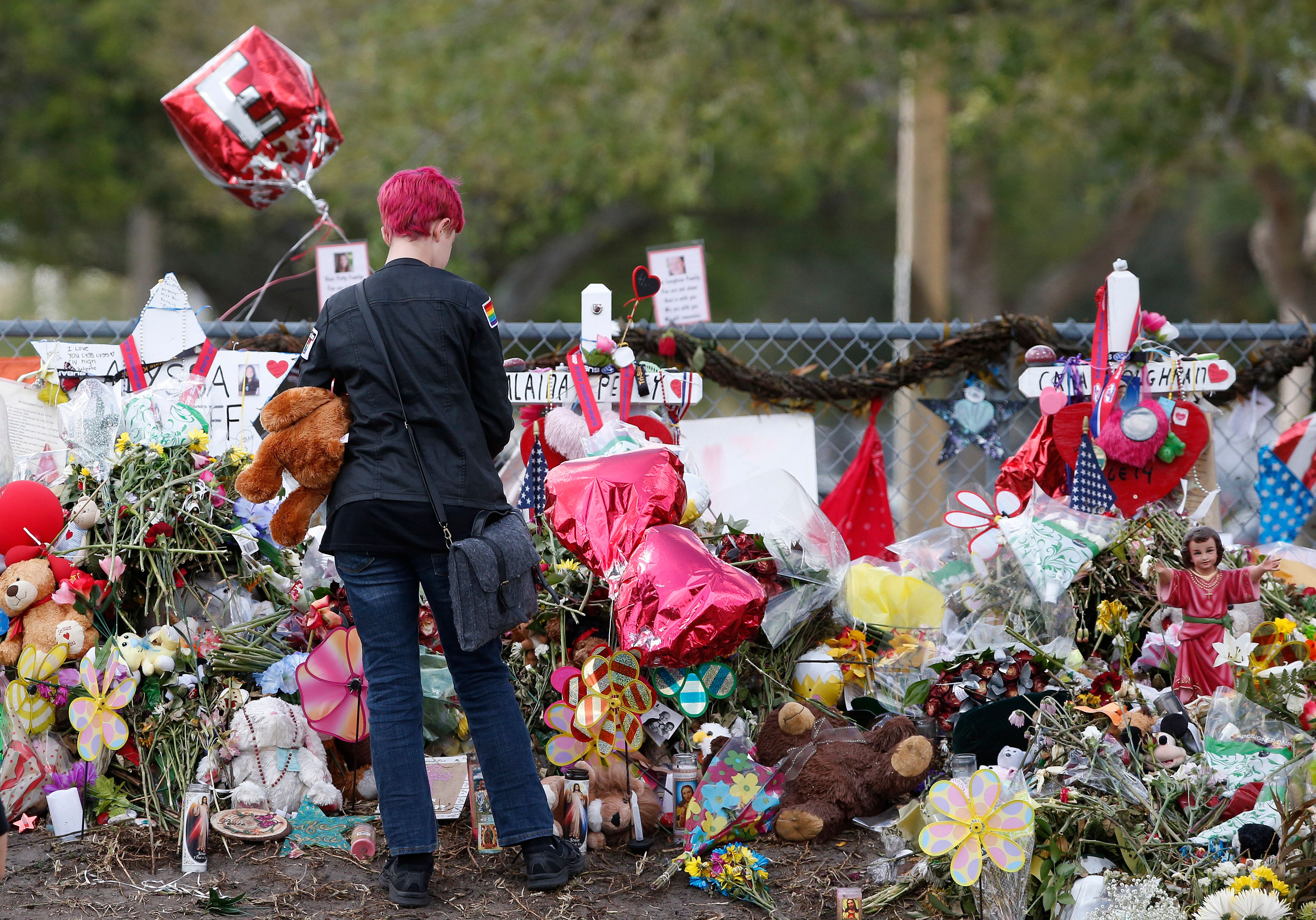 A Marjory Stoneman Douglas High School student at a memorial following students' return to school in Parkland, Florida on February 28, 2018.
