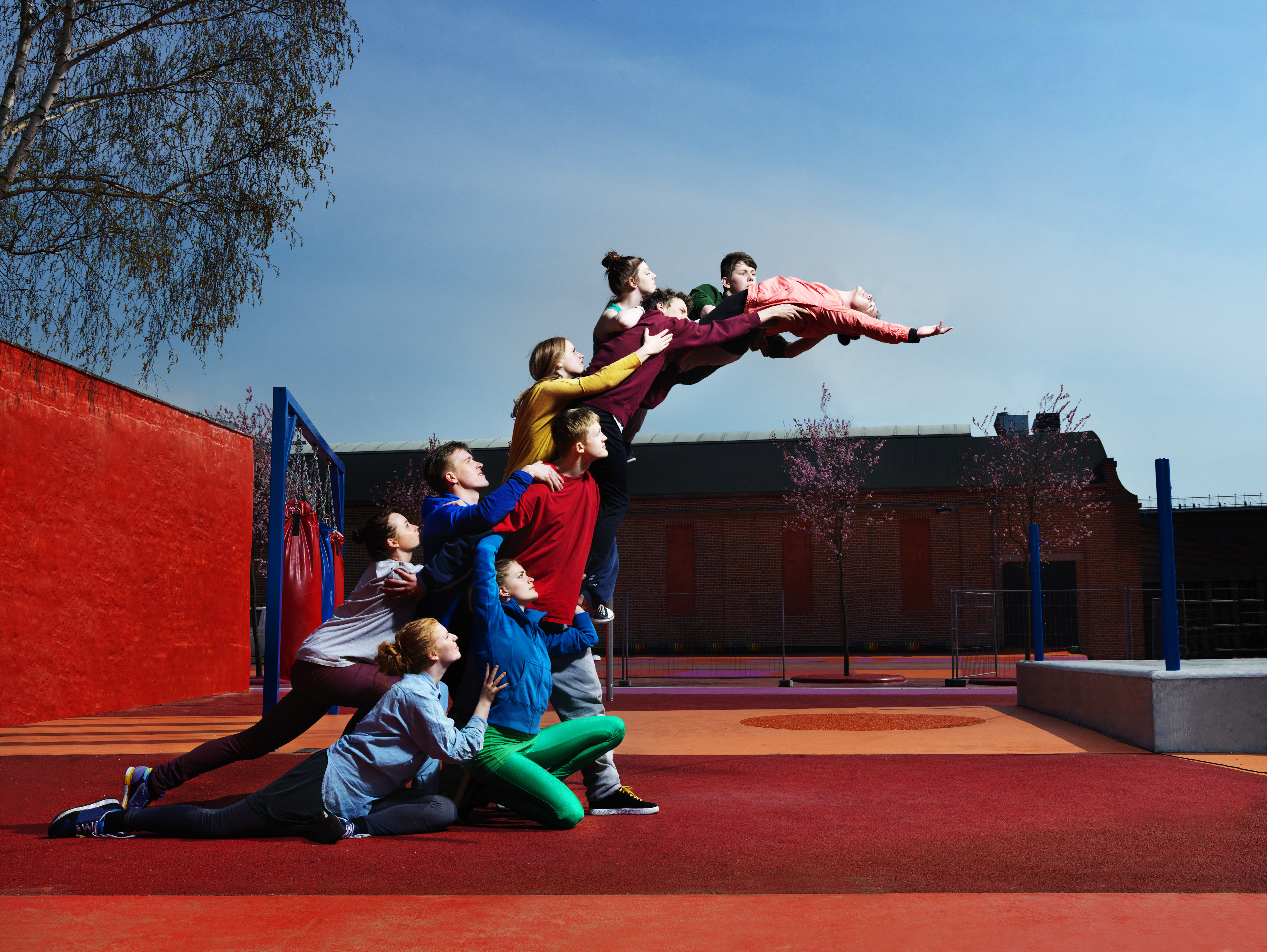 young people creating human statue