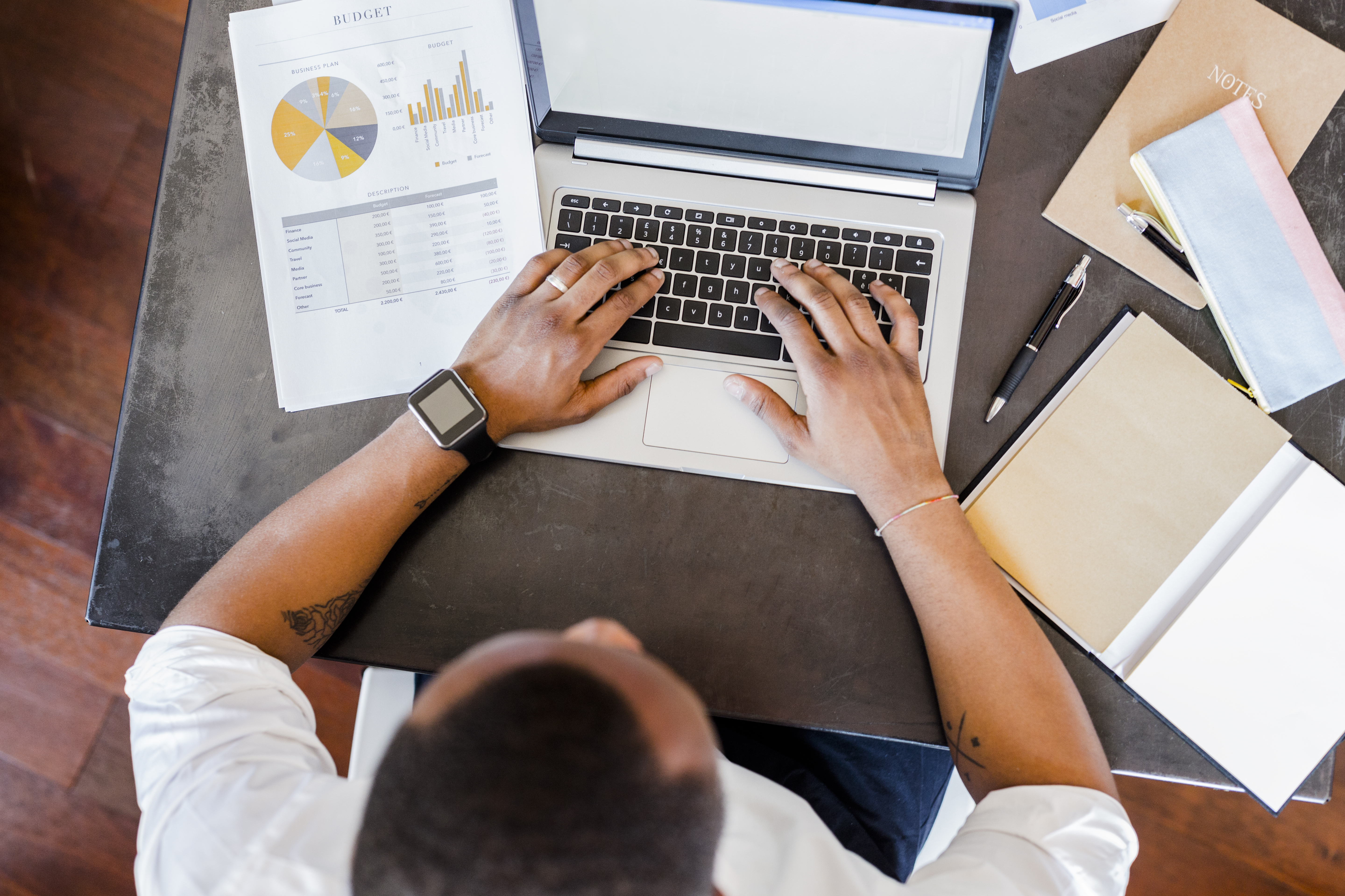 Man using laptop at desk in home office