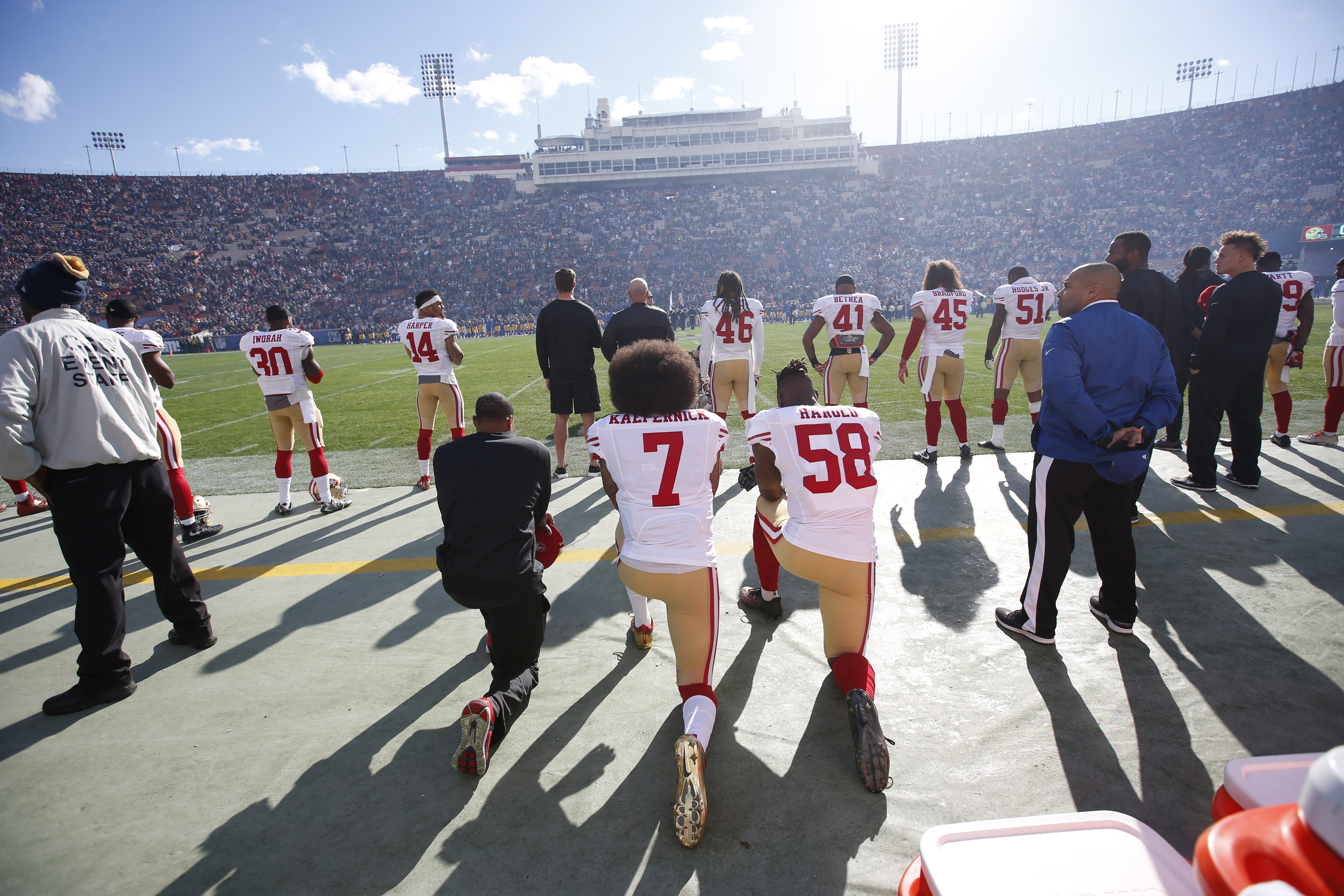 Eric Reid #35, Colin Kaepernick #7 and Eli Harold #58 of the San Francisco 49ers kneel next to each other on the sideline, during the anthem, prior to the game against the Los Angeles Rams at the Los Angeles Coliseum.