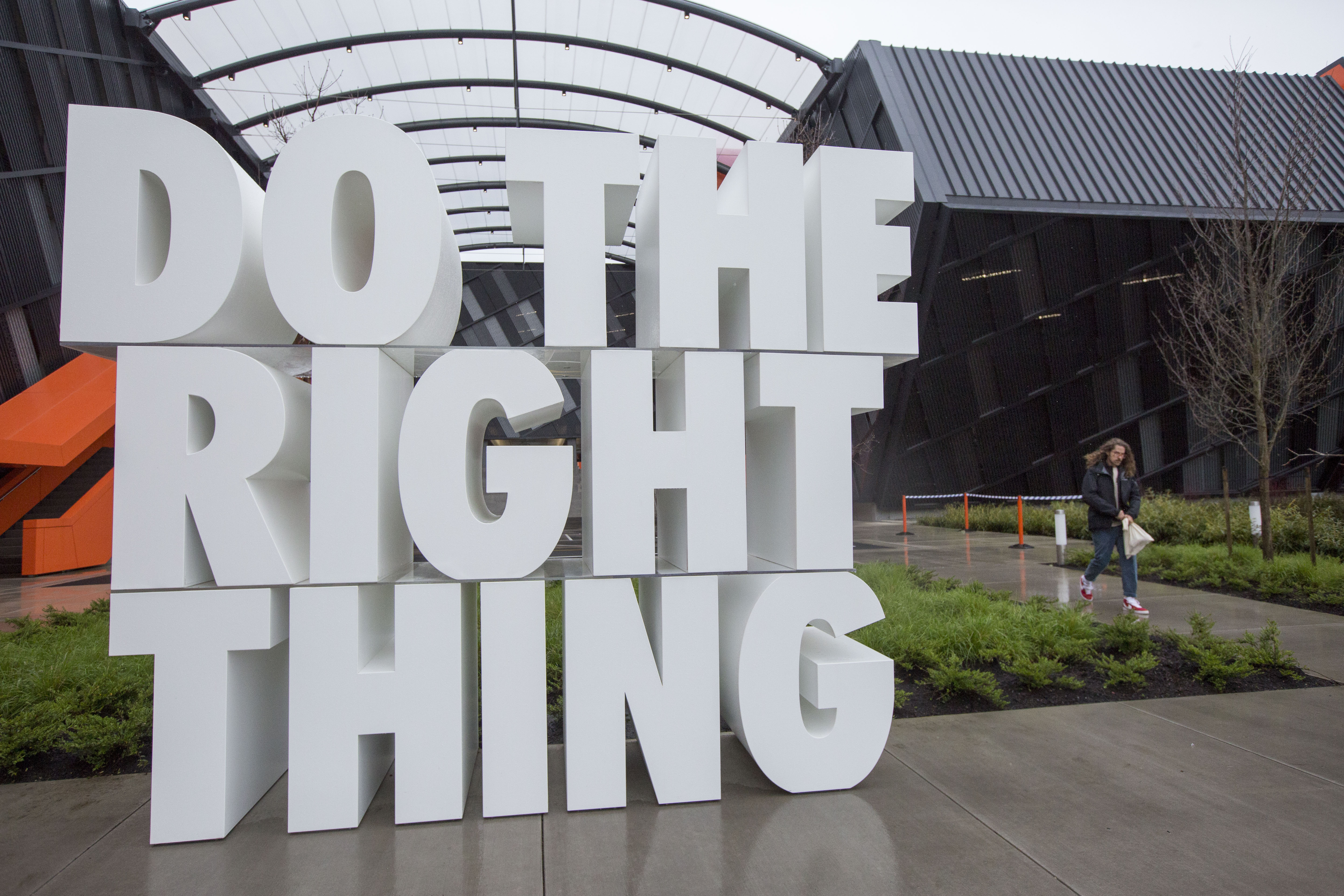A giant sculpture reads "Do the right thing," in white Nike lettering in front of the company's headquarters