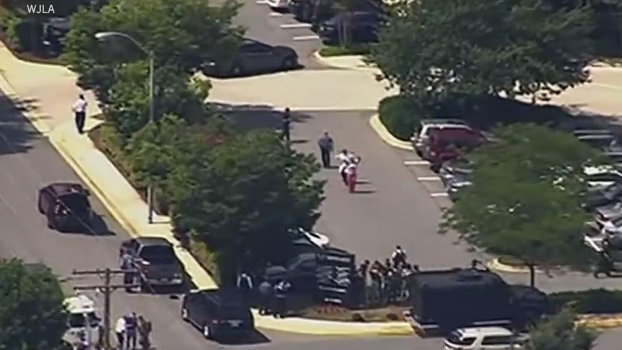 In this frame from video, people leave the Capital Gazette newspaper after multiple people have been shot on Thursday, June 28, 2018, in Annapolis, Md. (WJLA via AP)