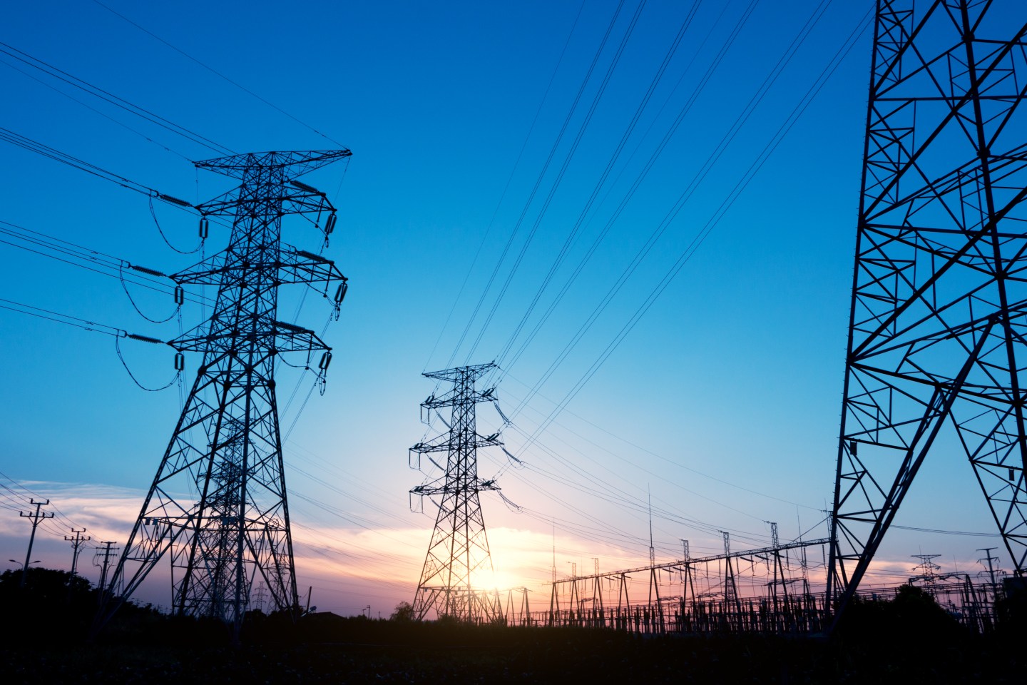 pylons near power transform station at sunrise