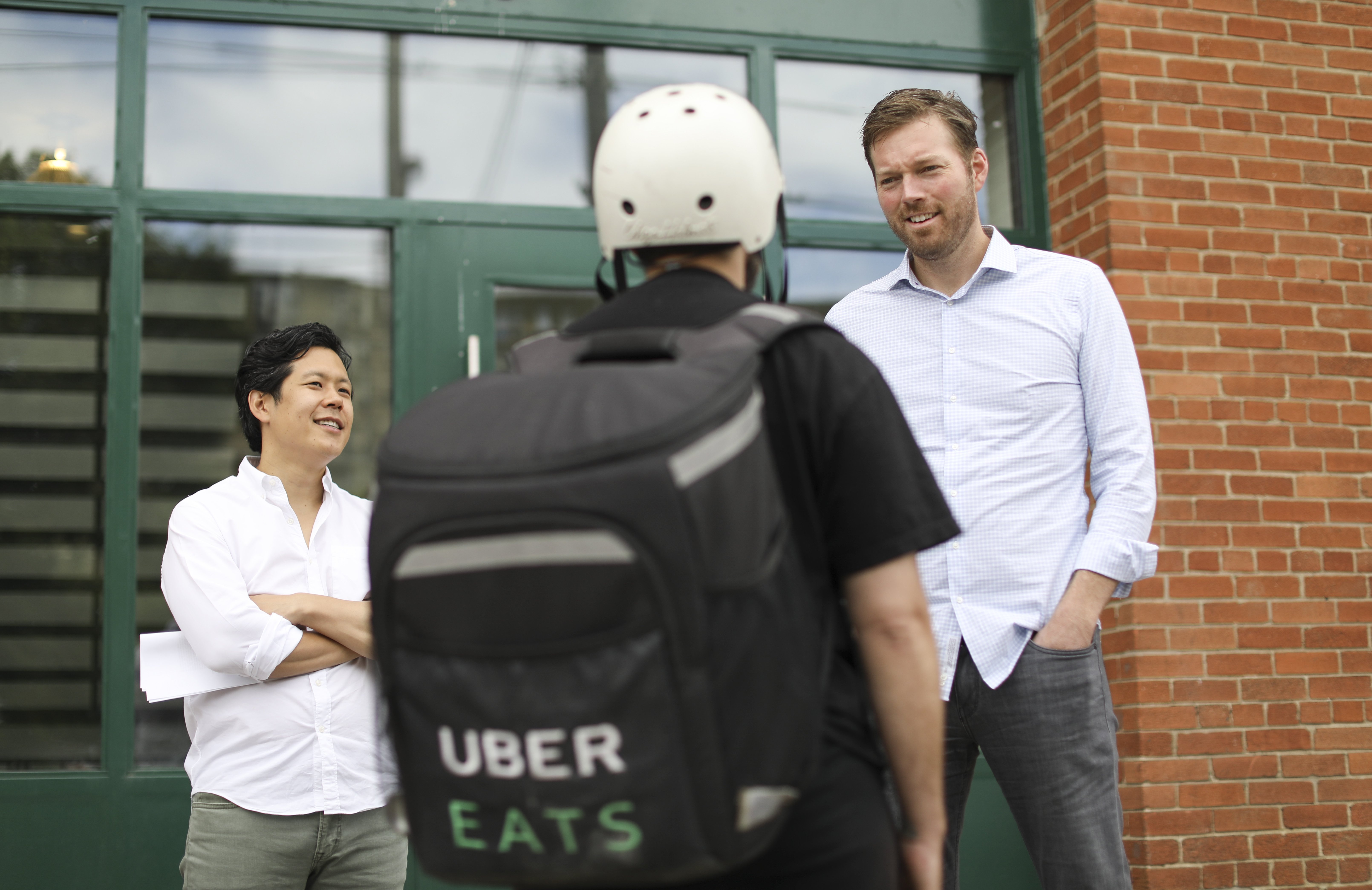 Guy with an Uber Eats backpack making a delivery