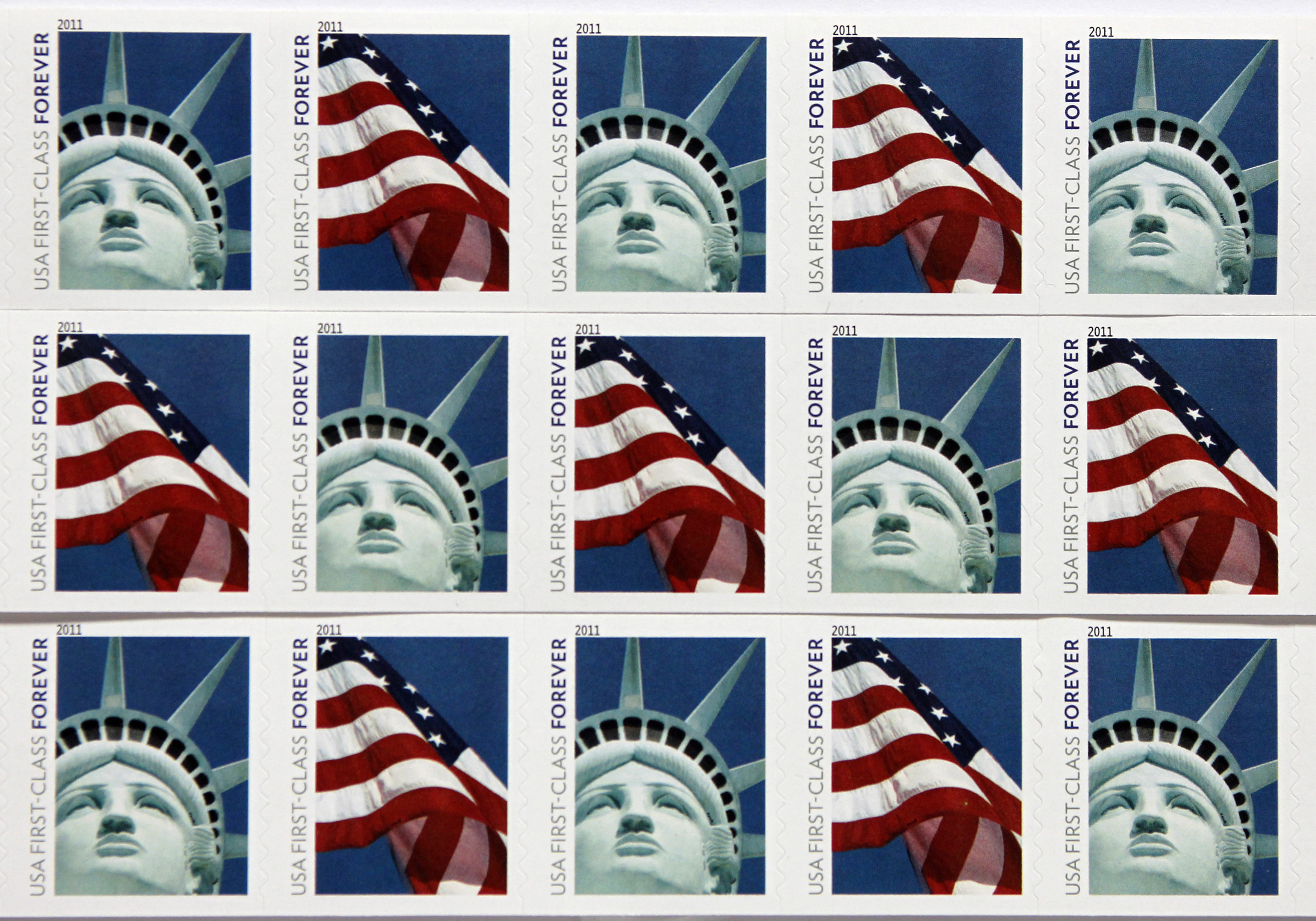 New USA First Class postage stamps, bearing an image of the Statue of Liberty and U.S. flags, are seen in Washington, April 15, 2011. The new U.S. first-class postage stamp, which shows a low-angled close-up of Lady Liberty's face and crown, was issued in December, according to an announcement about the "world-recognized" symbol of the United States. The statement described the statue as a gift from the people of France, designed by sculptor Frederic-Auguste Bartholdi, which stands 305 feet tall on Liberty Island off the tip of Manhattan, "a symbol of political freedom and democracy for millions of people around the world." None of this is quite true of the image shown on the stamp, which is actually a photo of a half-sized replica of the statue that was created for and stands outside the New York-New York Hotel & Casino in Las Vegas. REUTERS/Hyungwon Kang (UNITED STATES - Tags: SOCIETY) - GM1E74G0FF601