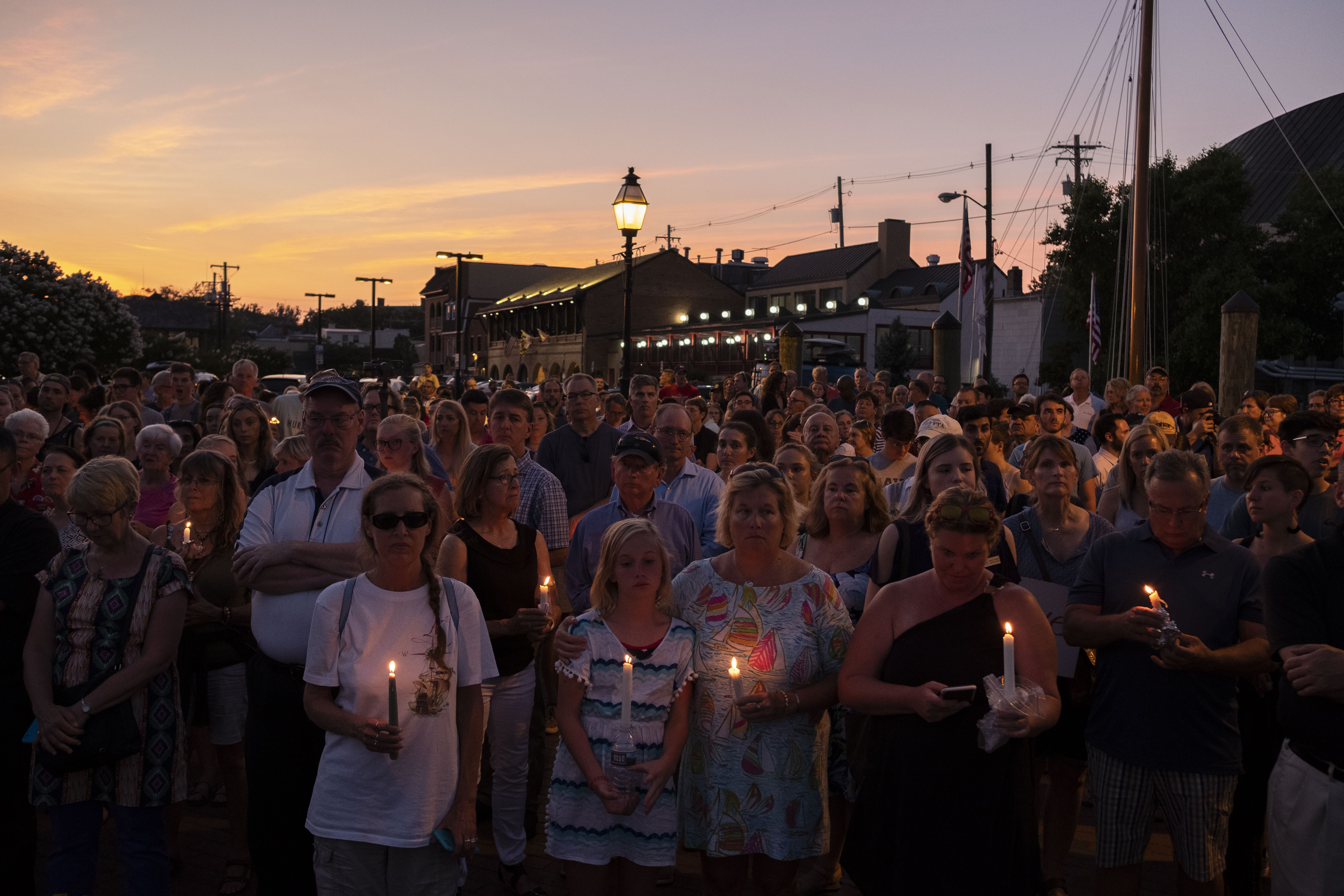 photos involving the Capital Gazette shooting in Annapolis and a candlelight vigil beginning at Lawyer's Mall at the State House, followed by a march to City Dock for a service
