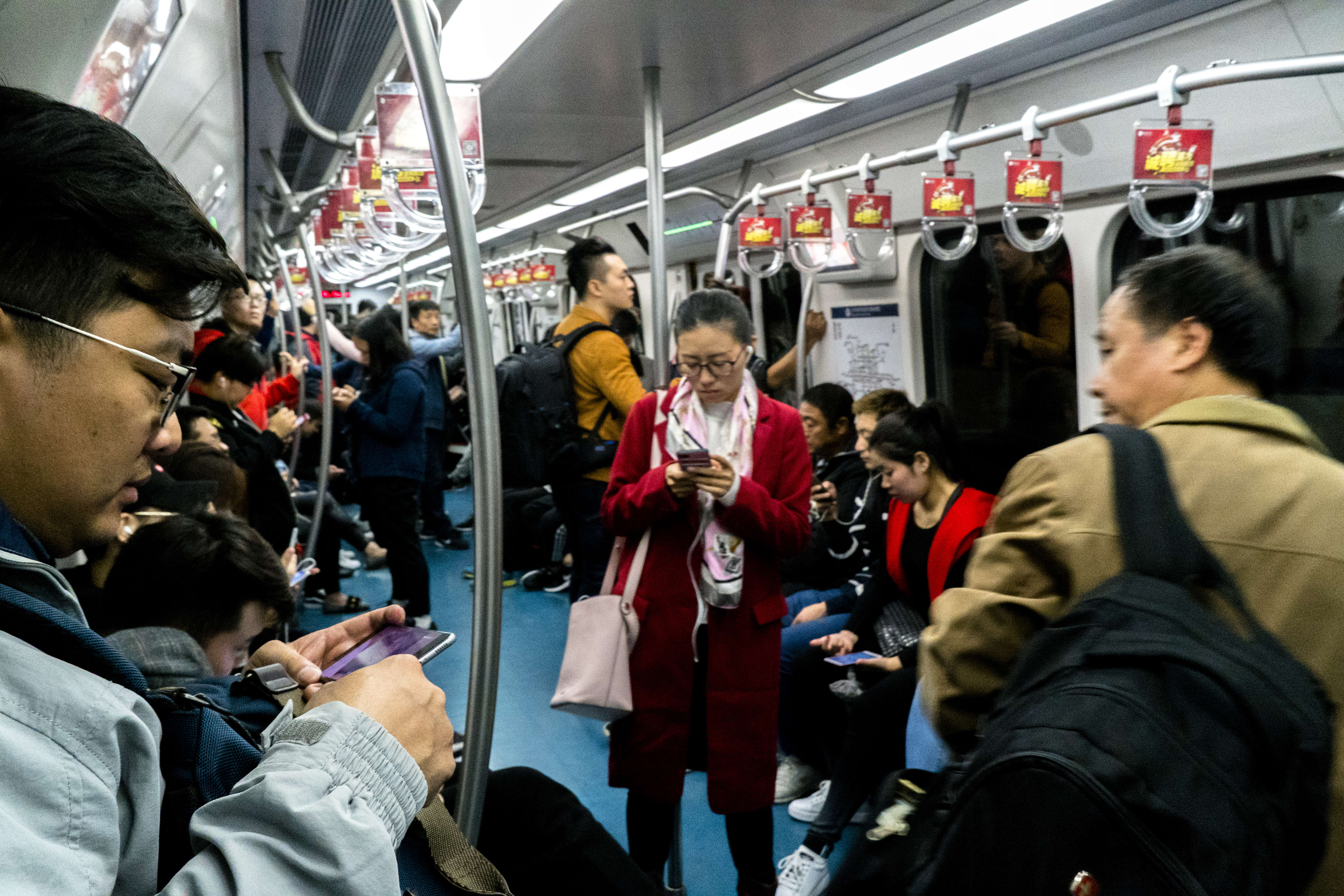 People are reading on smart phones in subway. Figures from