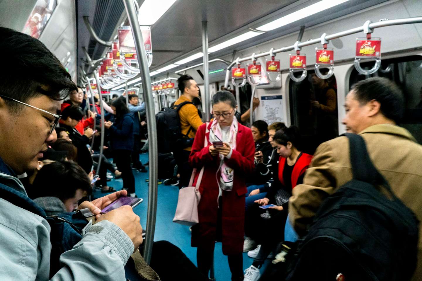 People are reading on smart phones in subway. Figures from