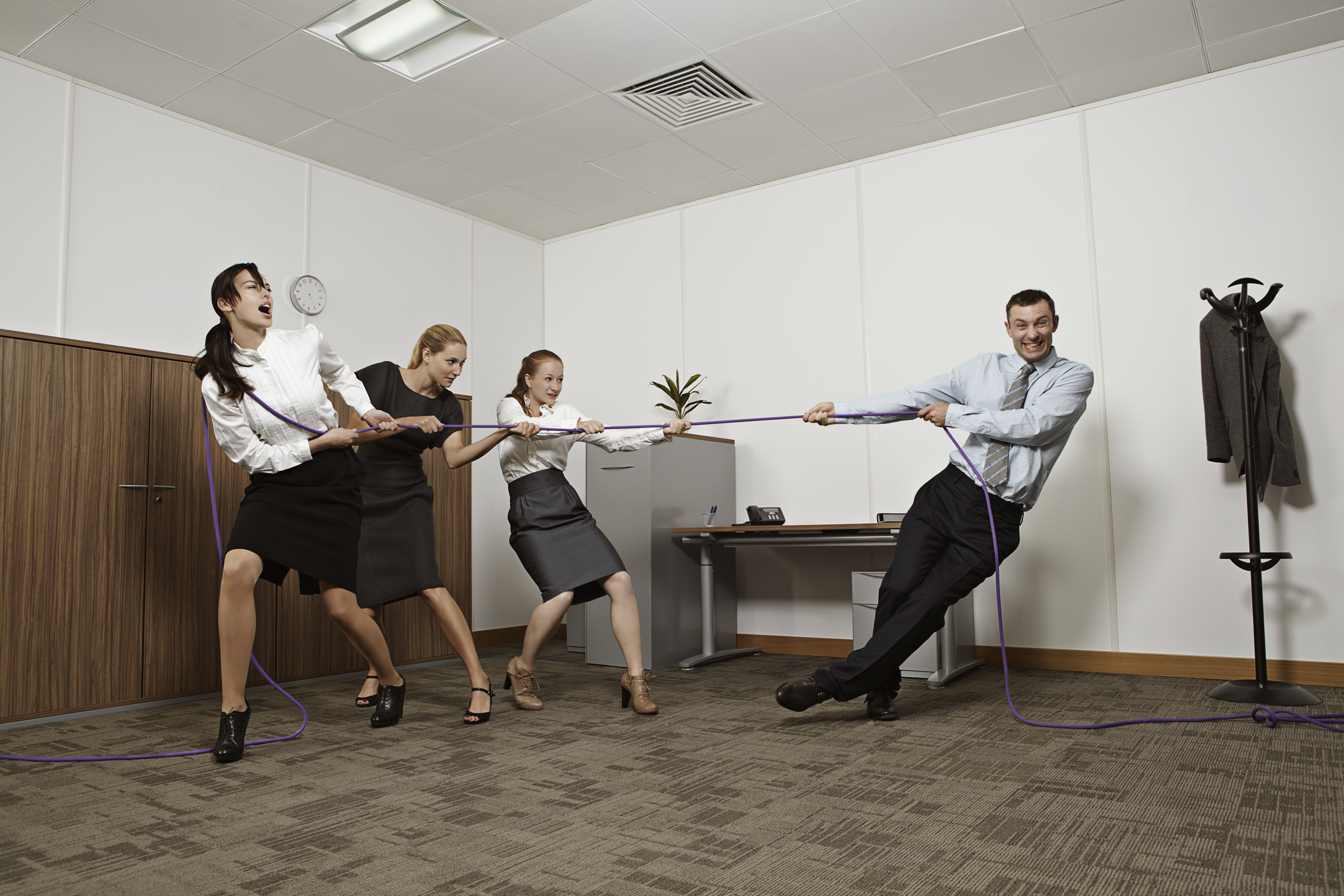 Coworkers playing tug-of-war