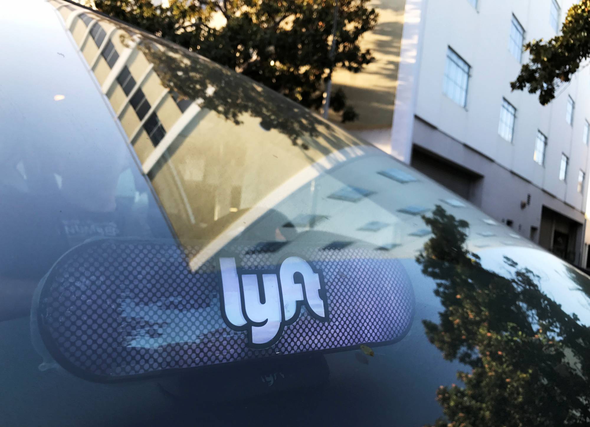 An illuminated sign appears in a Lyft ride-hailing car in Los Angeles