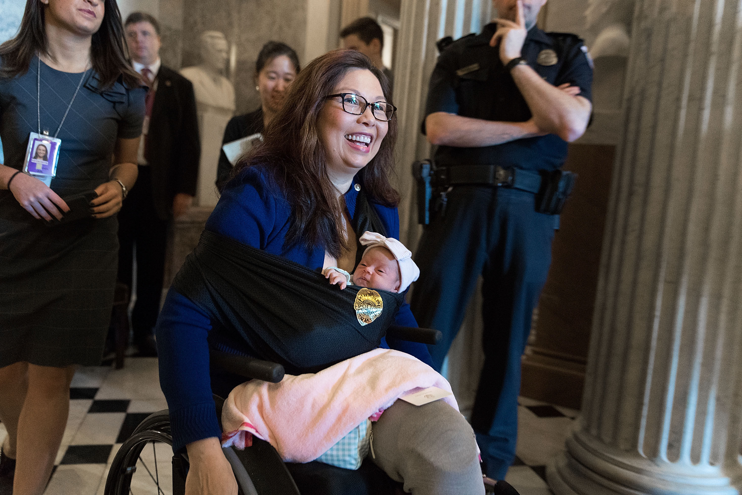 U.S. Sen. Tammy Duckworth leaves the Senate chamber after a vote with her newborn baby daughter Maile at the U.S. Capitol on April 26, 2018.